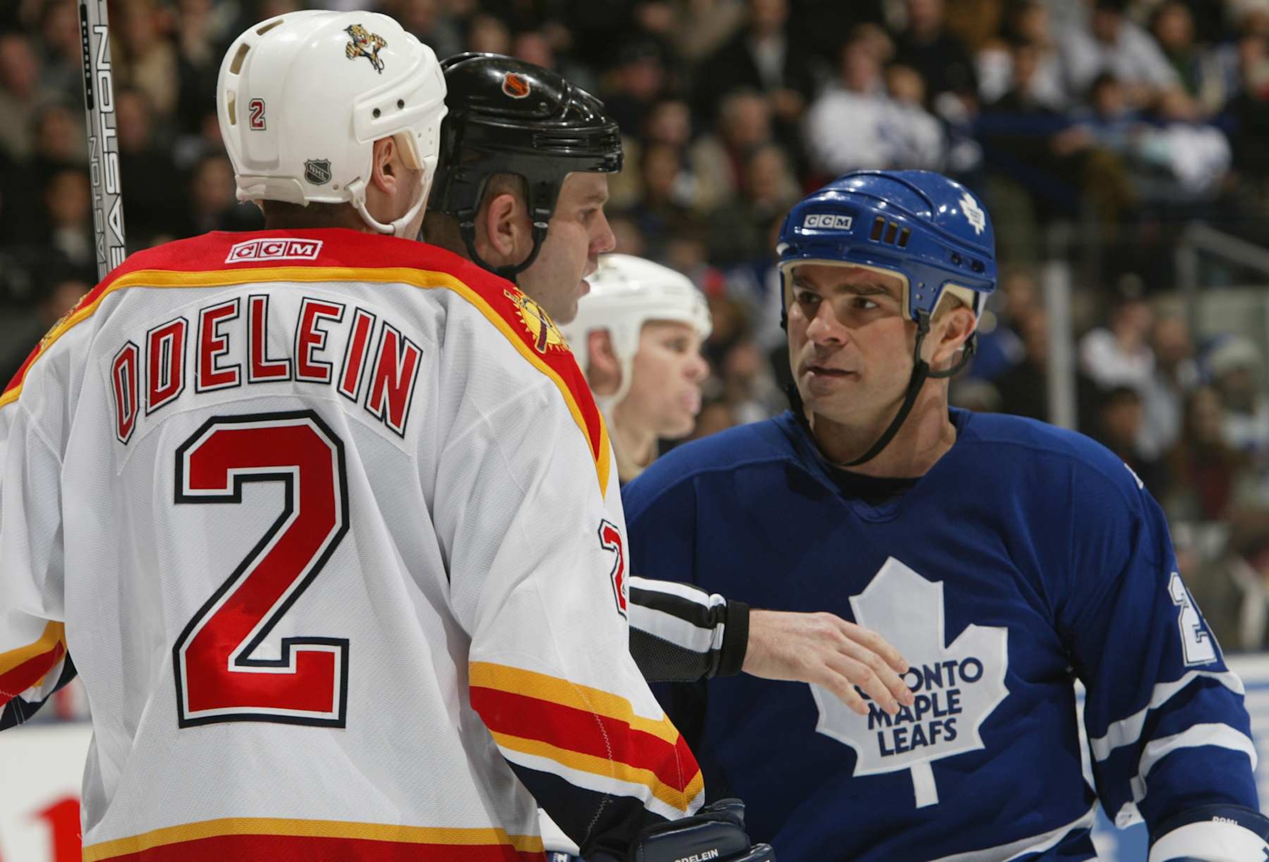 TORONTO - DECEMBER 23:  An NHL lineman separates Tie Domi #28 of the Toronto Maple Leafs and Lyle Odelein #2 of the Florida Panthers during the game at Air Canada Center on December 23, 2003 in Toronto, Ontario, Canada. The Maple Leafs won the game 5-2. (Photo By Dave Sandford/Getty Images)