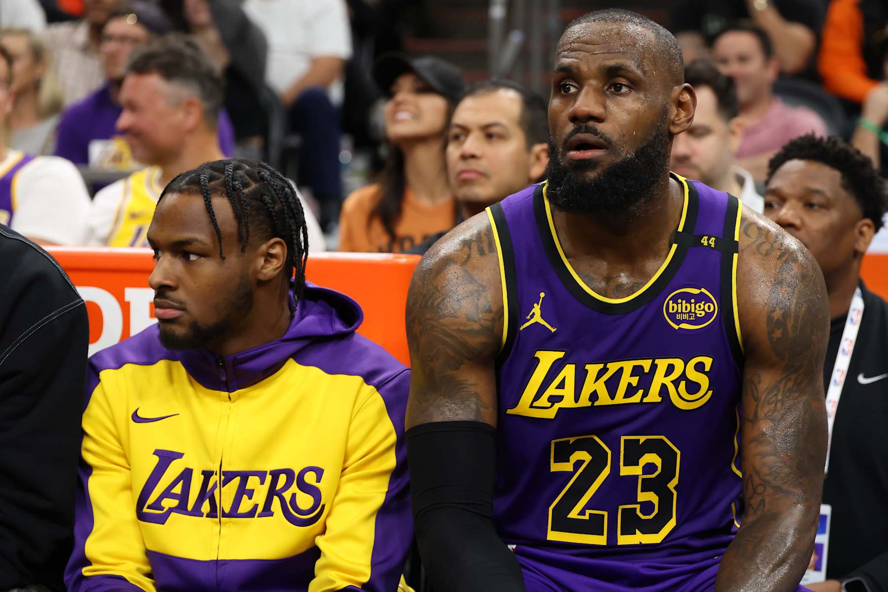 PHOENIX, ARIZONA - OCTOBER 28: Bronny James #9 and LeBron James #23 of the Los Angeles Lakers look on during the second half against the Phoenix Suns at Footprint Center on October 28, 2024 in Phoenix, Arizona. NOTE TO USER: User expressly acknowledges and agrees that, by downloading and or using this photograph, User is consenting to the terms and conditions of the Getty Images License Agreement. (Photo by Christian Petersen/Getty Images)
