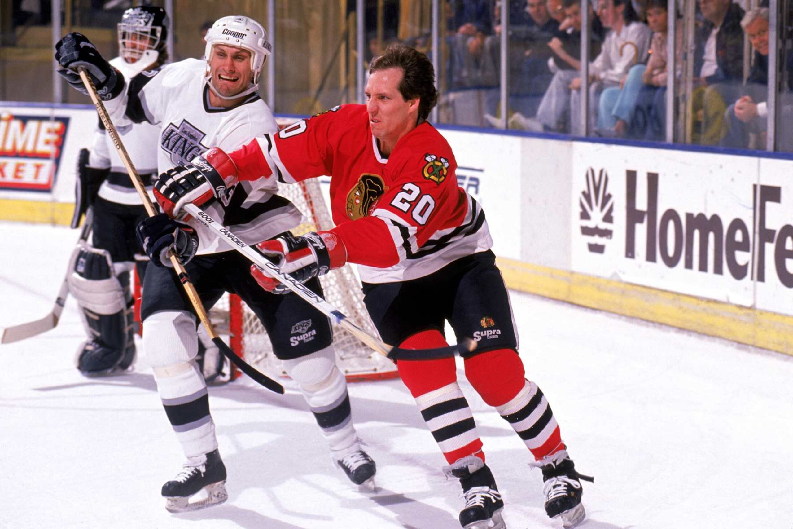 INGLEWOOD, CA - 1989:  Left wing Al Secord #20 of the Chicago Blackhawks (sans helmet) checks his opponent during a game against the Los Angeles Kings at the Great Western Forum during the 1989-90 season in Inglewood, California.  (Photo by Mike Powell/Getty Images)