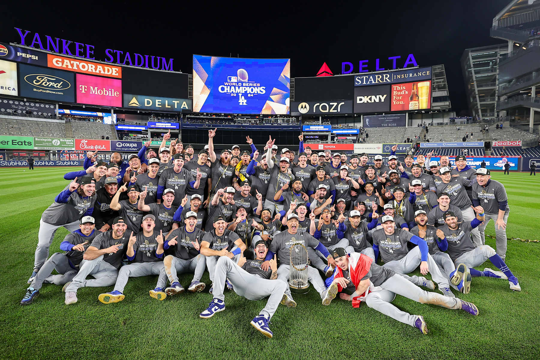 NEW YORK, NY - OCTOBER 30: Members of the Los Angeles Dodgers pose for a team photo on the field after defeating the New York Yankees in Game 5 of the 2024 World Series presented by Capital One between the Los Angeles Dodgers and the New York Yankees at Yankee Stadium on Wednesday, October 30, 2024 in New York, New York. (Photo by Dustin Satloff/MLB Photos via Getty Images)