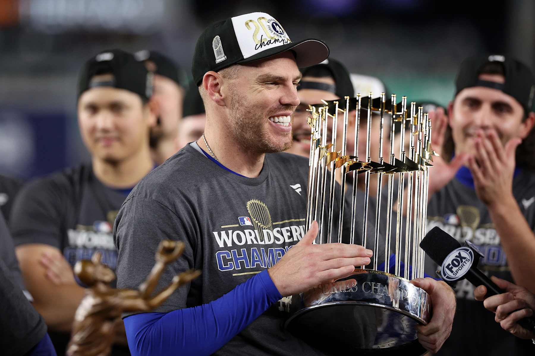NEW YORK, NEW YORK - OCTOBER 30:  Freddie Freeman #5 of the Los Angeles Dodgers celebrates with the trophy after the Dodgers defeated the New York Yankees 7-6 in game 5 to win the 2024 World Series at Yankee Stadium on October 30, 2024 in the Bronx borough of New York City. (Photo by Elsa/Getty Images)