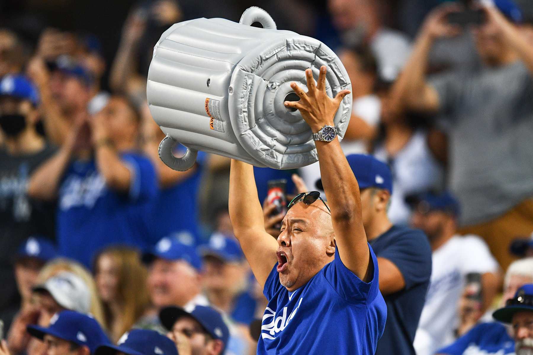 LOS ANGELES, CA - AUGUST 03: A Dodgers fan bangs a blowup trash can during the MLB game between the Houston Astros and the Los Angeles Dodgers on August 3, 2021 at Dodger Stadium in Los Angeles, CA. (Photo by Brian Rothmuller/Icon Sportswire via Getty Images)