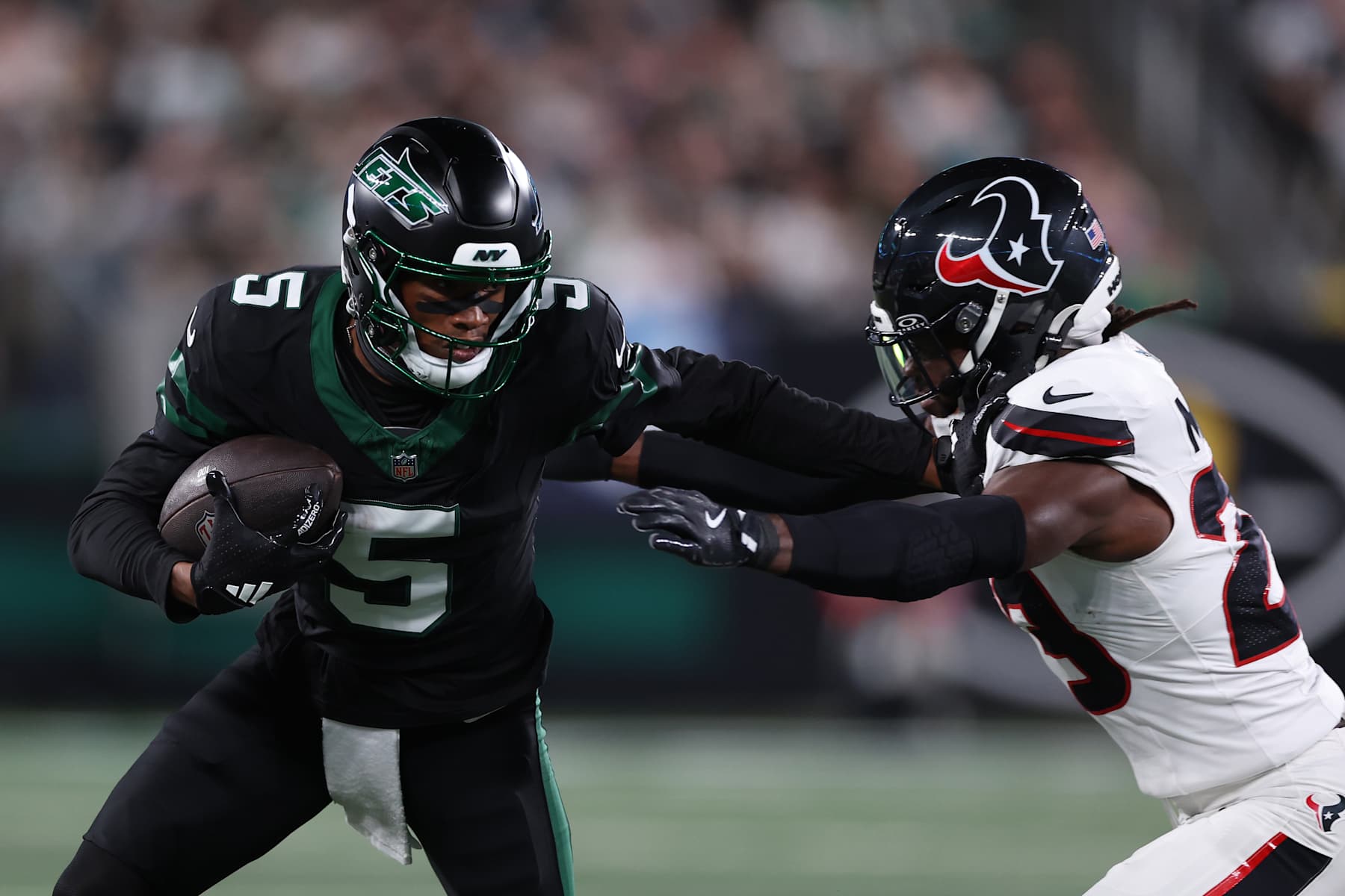 EAST RUTHERFORD, NEW JERSEY - OCTOBER 31: Garrett Wilson #5 of the New York Jets is tackled by Eric Murray #23 of the Houston Texans during the first quarter at MetLife Stadium on October 31, 2024 in East Rutherford, New Jersey. (Photo by Luke Hales/Getty Images)