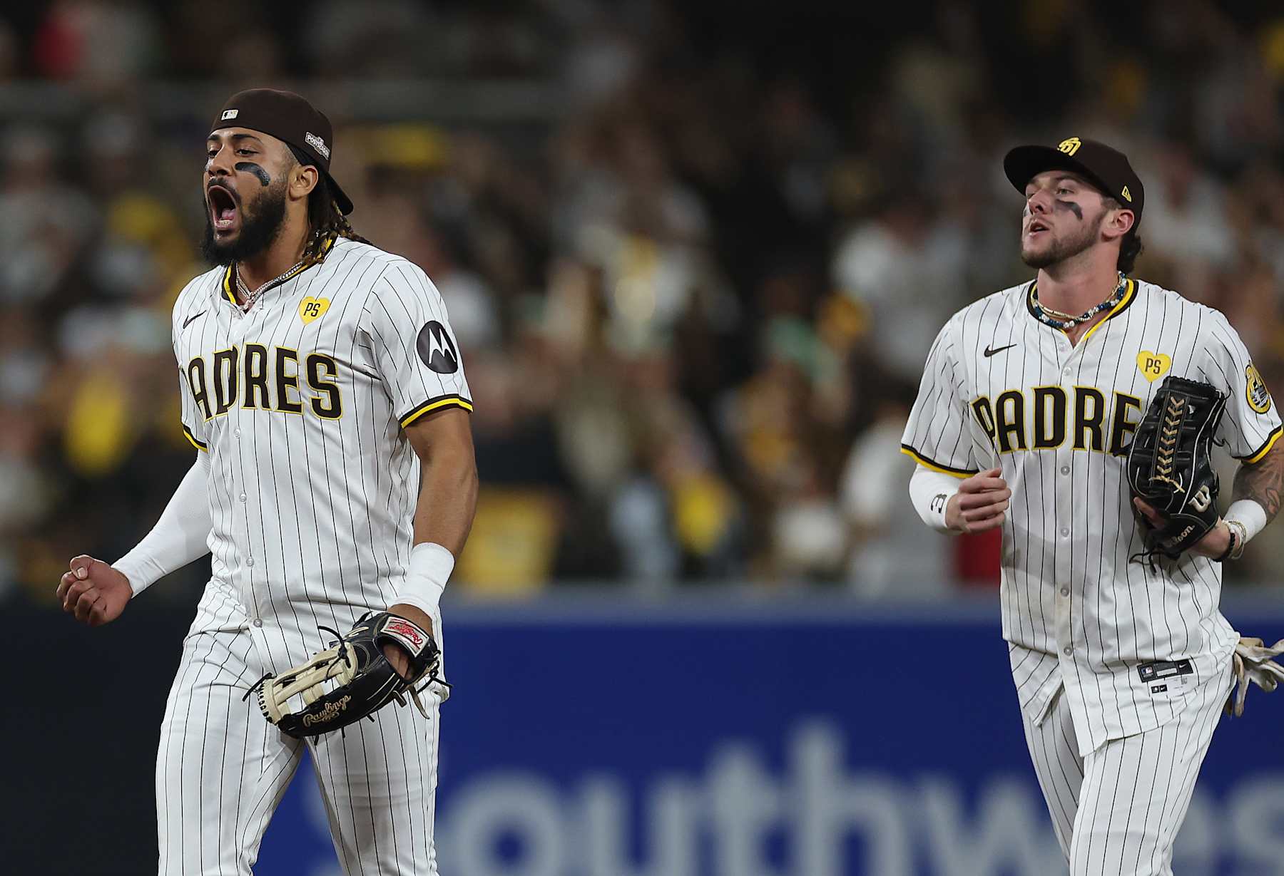 SAN DIEGO, CALIFORNIA - OCTOBER 08: Fernando Tatis Jr. #23 and Jackson Merrill #3 of the San Diego Padres celebrate after beating the Los Angeles Dodgers 6-5 in Game Three of the Division Series at Petco Park on October 08, 2024 in San Diego, California. (Photo by Sean M. Haffey/Getty Images)