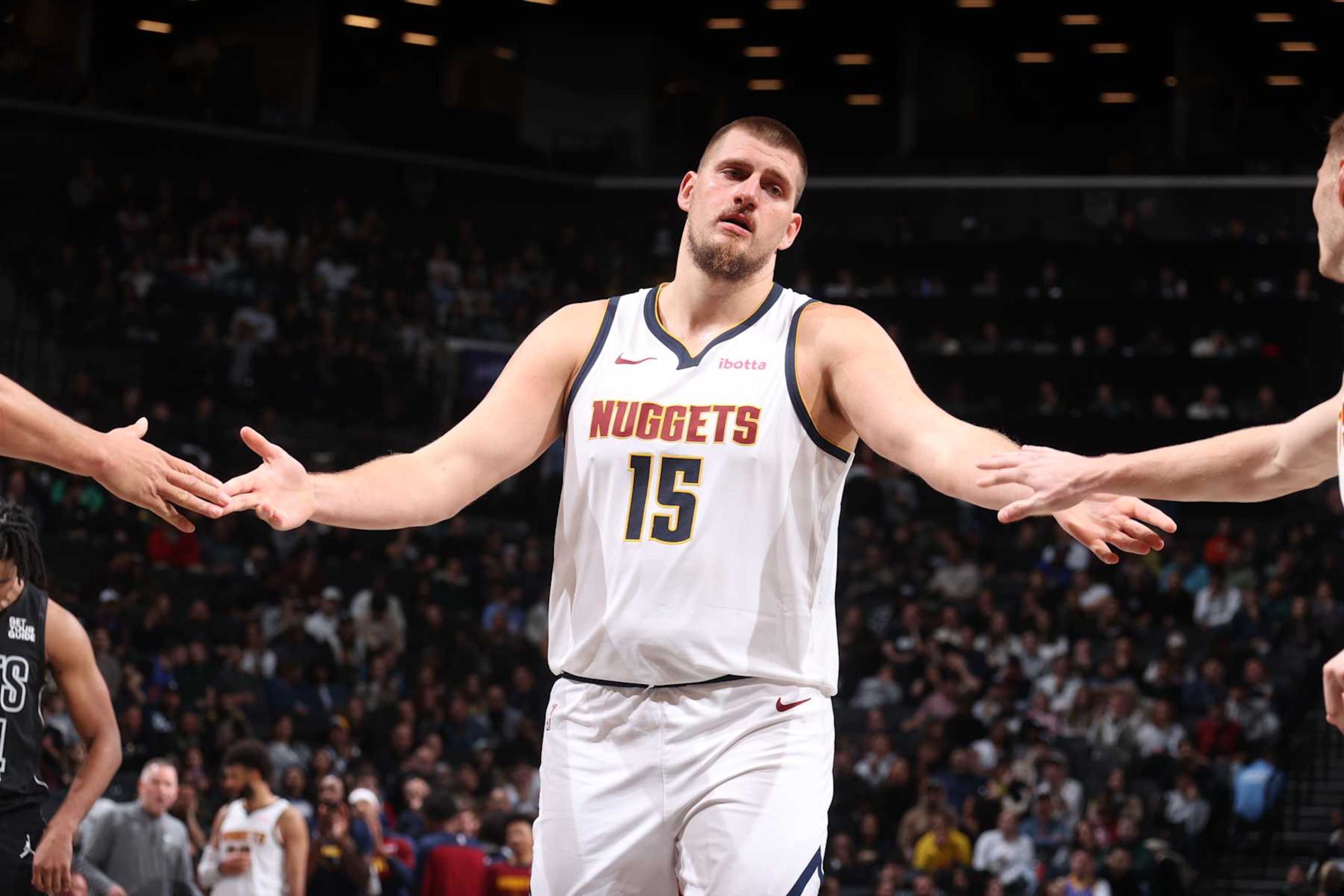 BROOKLYN, NY - OCTOBER 29: Nikola Jokic #15 of the Denver Nuggets high fives during the game against the Brooklyn Nets on October 29, 2024 at Barclays Center in Brooklyn, New York. NOTE TO USER: User expressly acknowledges and agrees that, by downloading and or using this Photograph, user is consenting to the terms and conditions of the Getty Images License Agreement. Mandatory Copyright Notice: Copyright 2024 NBAE (Photo by Nathaniel S. Butler/NBAE via Getty Images)