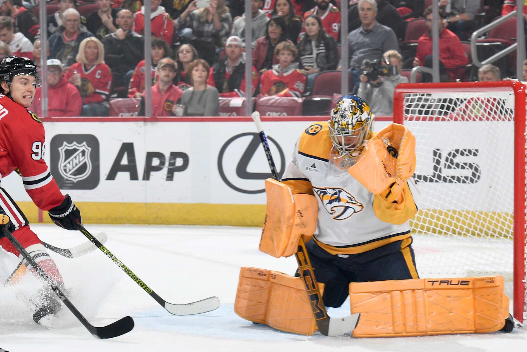 Nashville Predators goaltender Juuse Saros makes a save on Chicago Blackhawks center Connor Bedard.