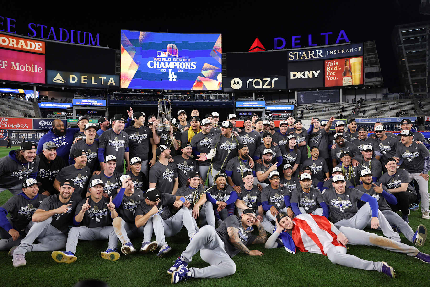 NEW YORK, NEW YORK - OCTOBER 30:  The Los Angeles Dodgers pose on the field after defeating the New York Yankees 7-6 in game 5 to win the 2024 World Series at Yankee Stadium on October 30, 2024 in the Bronx borough of New York City. (Photo by Elsa/Getty Images)