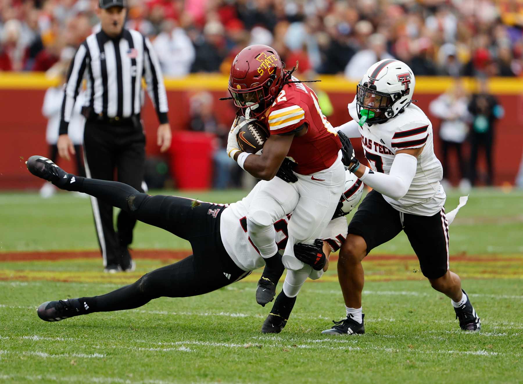 AMES, IA - NOVEMBER 02: Running back Jaylon Jackson #12 of the Iowa State Cyclones is tackled by linebacker Ben Roberts #13, and defensive back Brenden Jordan #7 of the Texas Tech Red Raiders as he rushed for yards in the first half of play at Jack Trice Stadium on November 2, 2024, in Ames, Iowa. (Photo by David Purdy/Getty Images)
