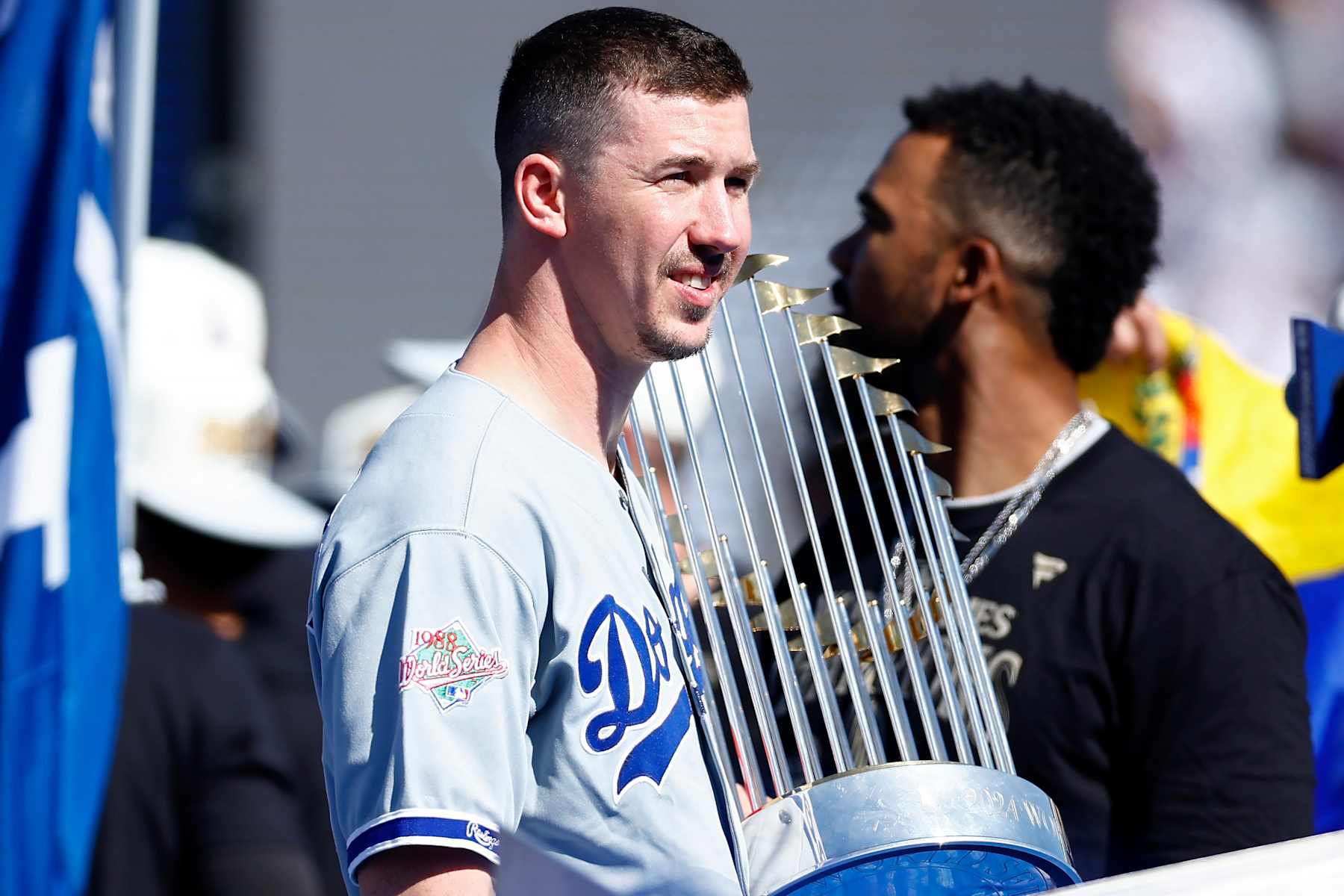 LOS ANGELES, CALIFORNIA - NOVEMBER 01: Walker Buehler #21 of the Los Angeles Dodgers enters the stadium with the Commissioners' Trophy during the 2024 World Series Celebration Show at Dodger Stadium on November 01, 2024 in Los Angeles, California. (Photo by Ronald Martinez/Getty Images)