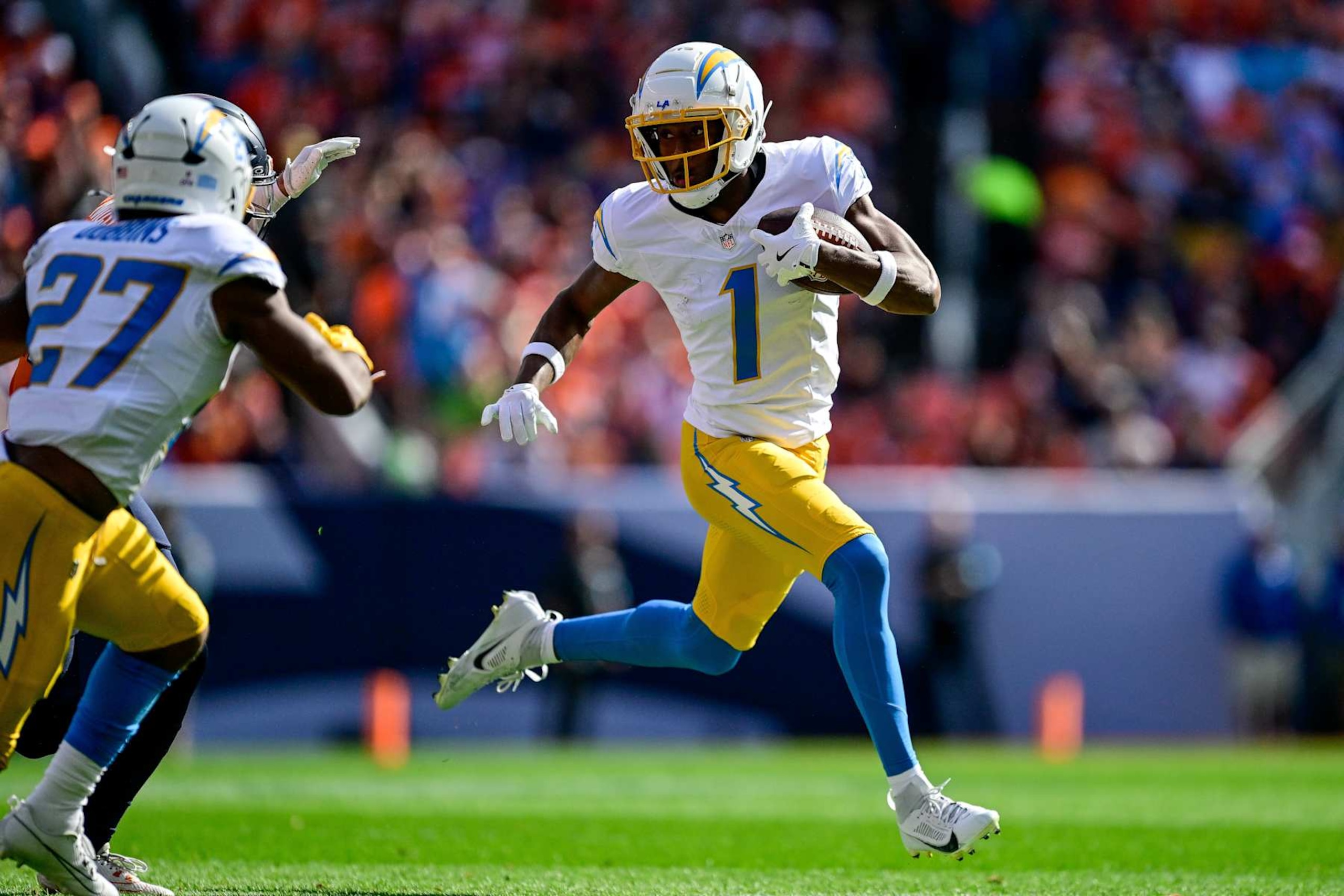 DENVER, COLORADO - OCTOBER 13:  Quentin Johnston #1 of the Los Angeles Chargers runs after a reception in the first quarter against the Denver Broncos at Empower Field at Mile High on October 13, 2024 in Denver, Colorado. (Photo by Dustin Bradford/Getty Images)