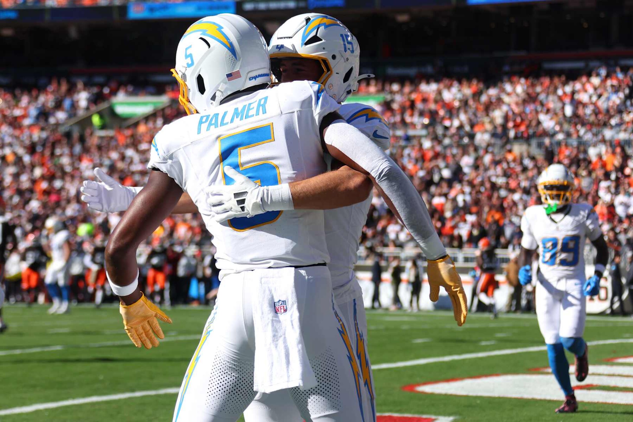 CLEVELAND, OHIO - NOVEMBER 03: Ladd McConkey #15 and Joshua Palmer #5 of the Los Angeles Chargers hug after Palmer's receiving touchdown in the first quarter of a game against the Cleveland Browns at Huntington Bank Field on November 03, 2024 in Cleveland, Ohio. (Photo by Gregory Shamus/Getty Images)
