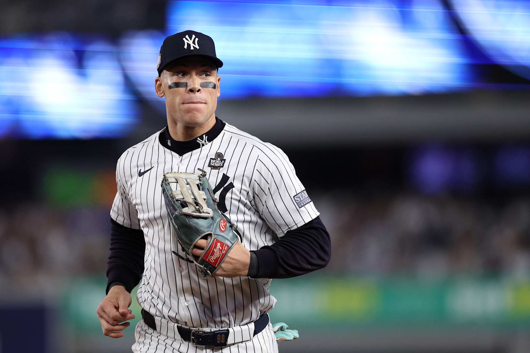 NEW YORK, NEW YORK - OCTOBER 30: Aaron Judge #99 of the New York Yankees jogs in at the end of the inning after catching a ball hit off the bat of Freddie Freeman #5 of the Los Angeles Dodgers at the wall during the fourth inning of Game Five of the 2024 World Series at Yankee Stadium on October 30, 2024 in the Bronx borough of New York City. (Photo by Elsa/Getty Images)