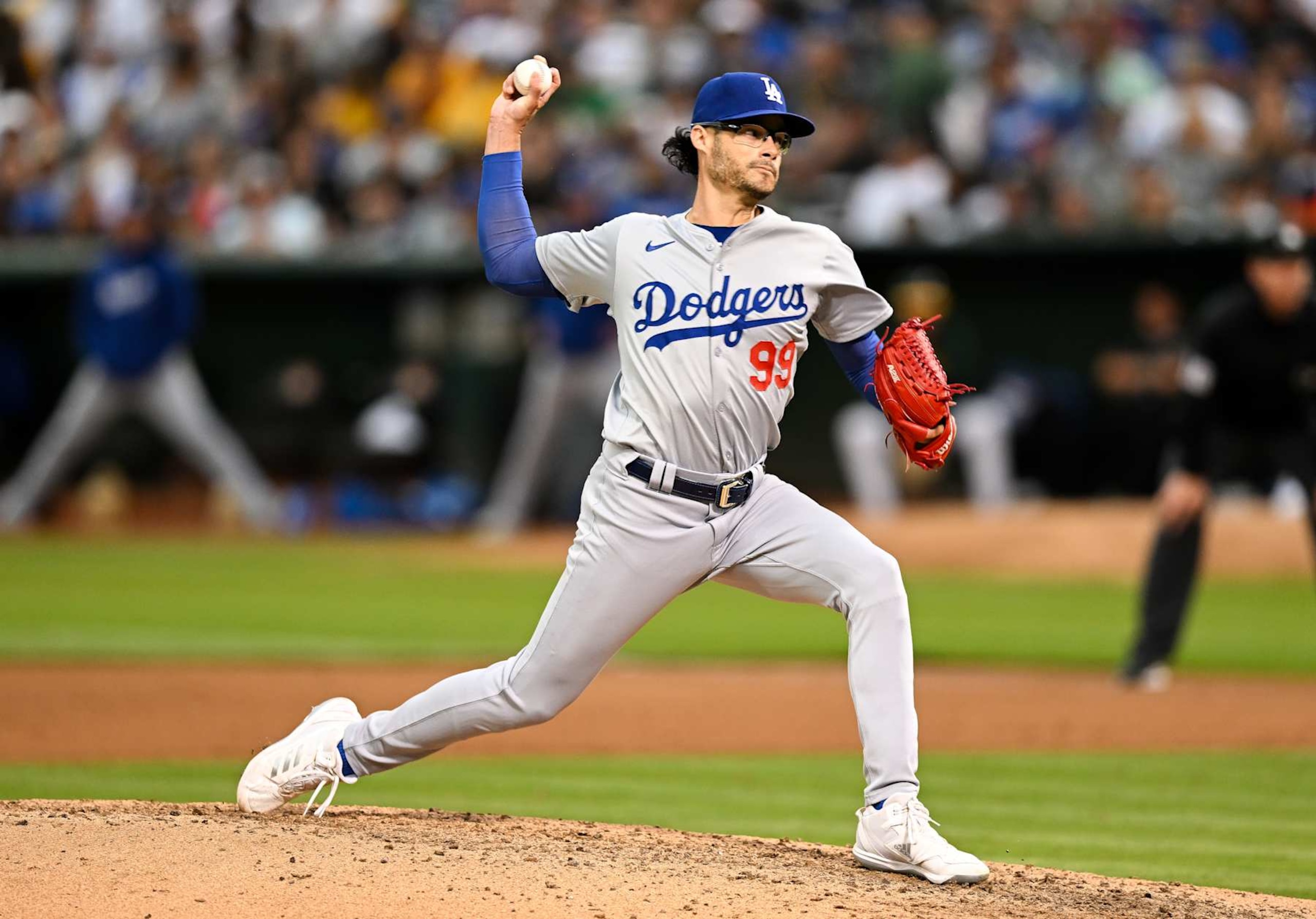 OAKLAND, CALIFORNIA - AUGUST 02: Joe Kelly #99 of Los Angeles Dodgers pitches in the bottom of the fifth inning during the regular season game against the Oakland Athletics at the Oakland Coliseum on August 2, 2024 in Oakland, California.  (Photo by Gene Wang/Getty Images)