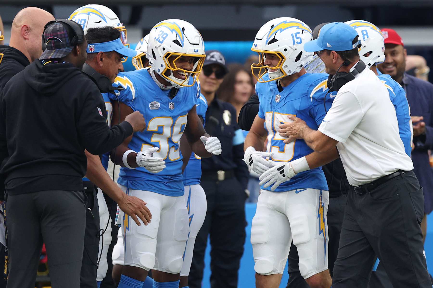 INGLEWOOD, CALIFORNIA - OCTOBER 27: Jaylen Johnson #39 and head coach Jim Harbaugh celebrate with Ladd McConkey #15 of the Los Angeles Chargers after McConkey's receiving touchdown in the third quarter of a game against the New Orleans Saints at SoFi Stadium on October 27, 2024 in Inglewood, California. (Photo by Harry How/Getty Images)