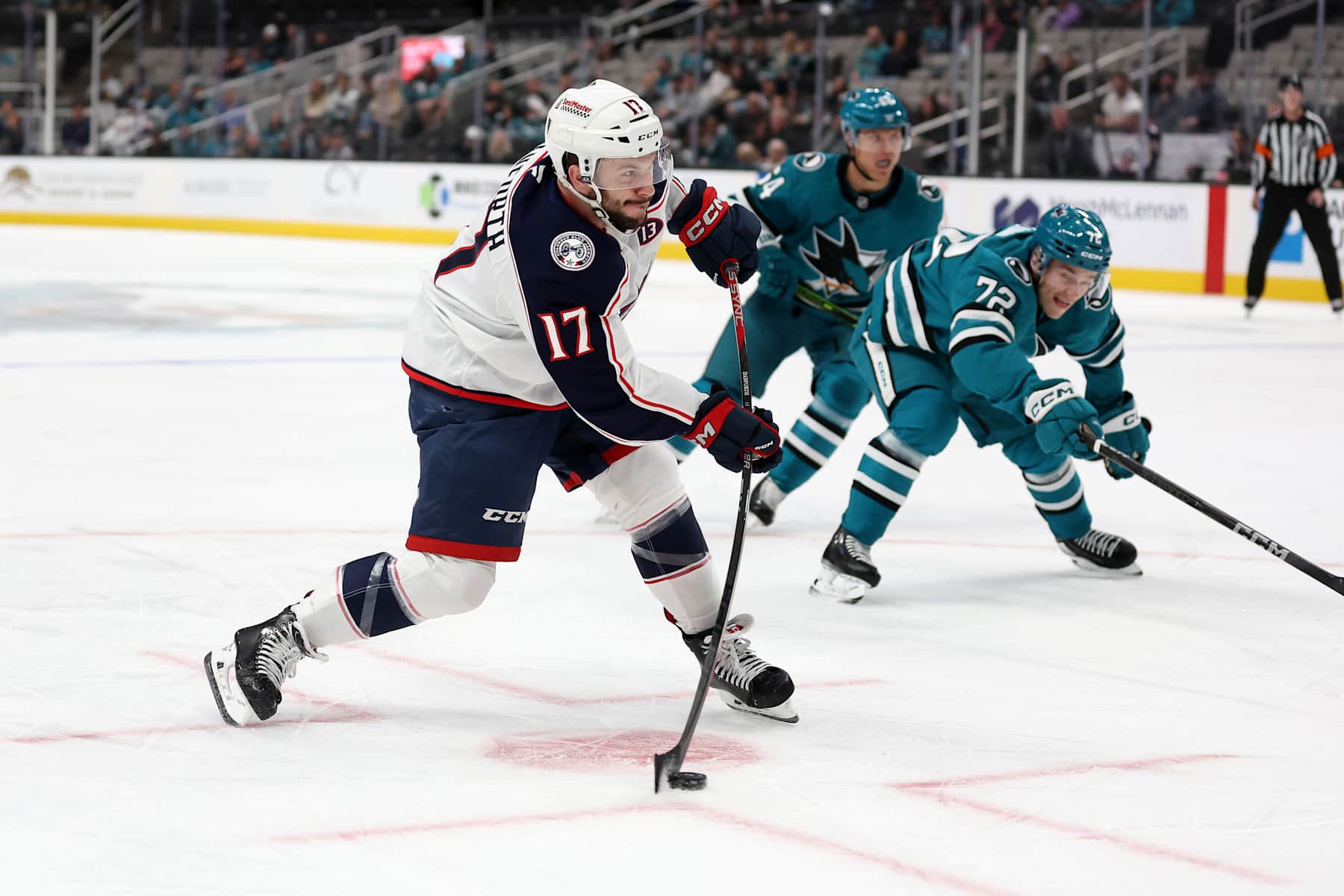 SAN JOSE, CALIFORNIA - NOVEMBER 05: Justin Danforth #17 of the Columbus Blue Jackets puts a shot on goal in front of William Eklund #72 of the San Jose Sharks in the first period at SAP Center on November 05, 2024 in San Jose, California. (Photo by Ezra Shaw/Getty Images)