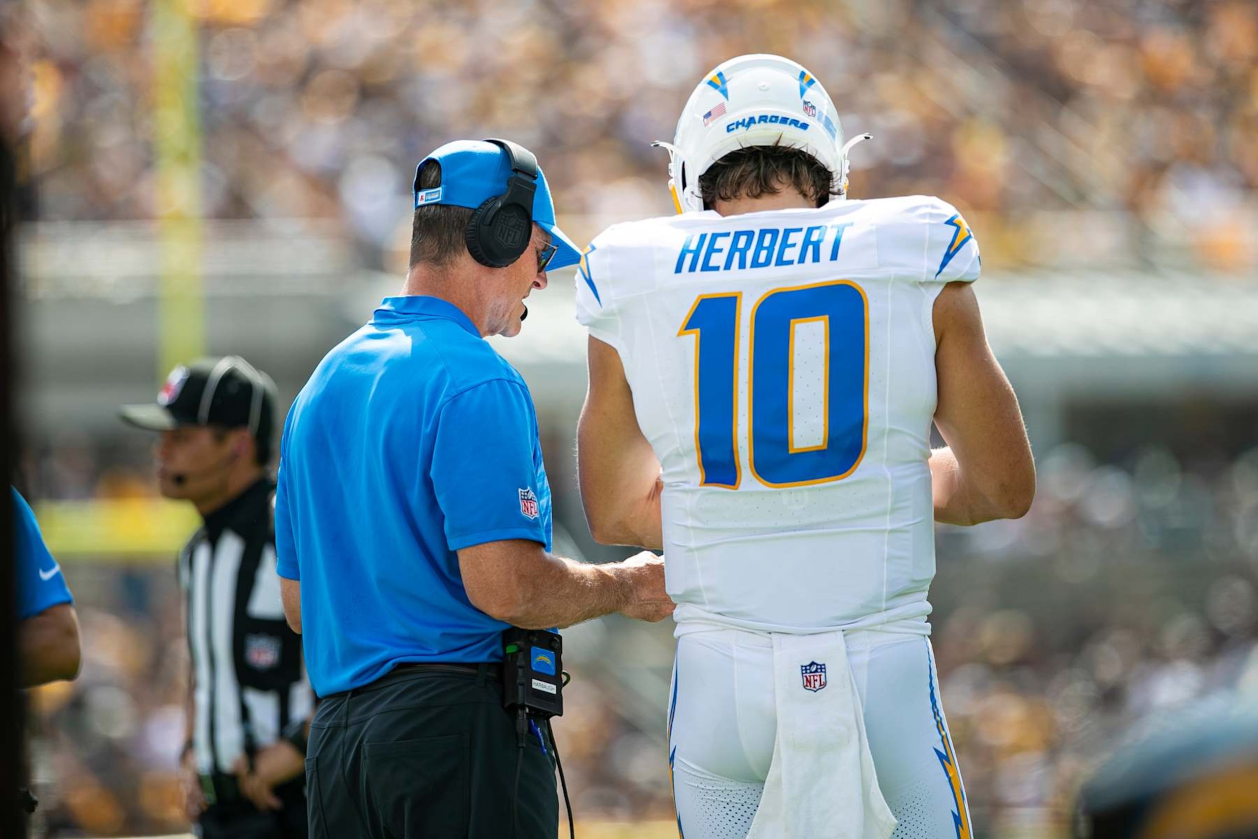 PITTSBURGH, PA - SEPTEMBER 22: Los Angeles Chargers quarterback Justin Herbert (10) talks with Los Angeles Chargers head coach Jim Harbaugh on the sideline during the regular season NFL football game between the Los Angeles Chargers and Pittsburgh Steelers on September 22, 2024 at Acrisure Stadium in Pittsburgh, PA. (Photo by Mark Alberti/Icon Sportswire via Getty Images)