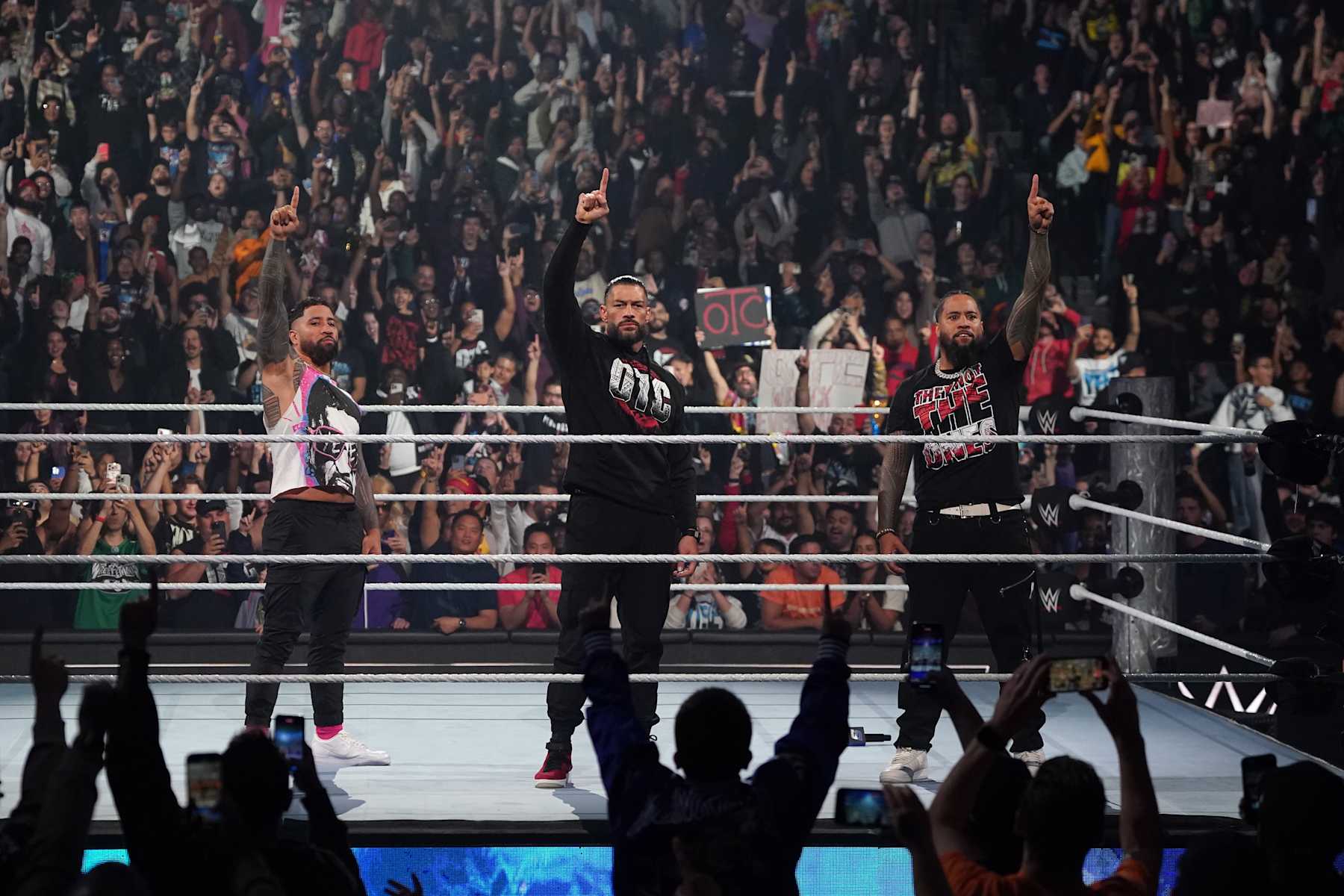NEW YORK, NEW YORK - NOVEMBER 1: (L-R) Jey Uso, Roman Reigns and Jimmy Uso make the 'We the Ones' gesture as they stand united in the ring during WWE SmackDown at Barclays Center on November 1, 2024 in New York City. (Photo by WWE/Getty Images)
