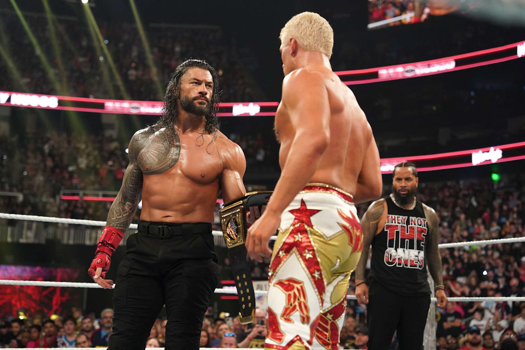 ATLANTA, GEORGIA - OCTOBER 5: Roman Reigns gives Cody Rhodes his title during Bad Blood at State Farm Arena on October 5, 2024 in Atlanta, Georgia. (Photo by WWE/Getty Images)