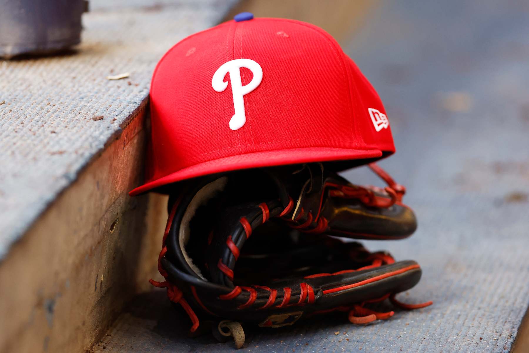 MILWAUKEE, WI - SEPTEMBER 16: A Philadelphia Phillies hat and glove sits on the dugout steps during a game between the Milwaukee Brewers and the Philadelphia Phillies at American Family Field on September 16, 2024 in Milwaukee, WI. (Photo by Larry Radloff/Icon Sportswire via Getty Images)