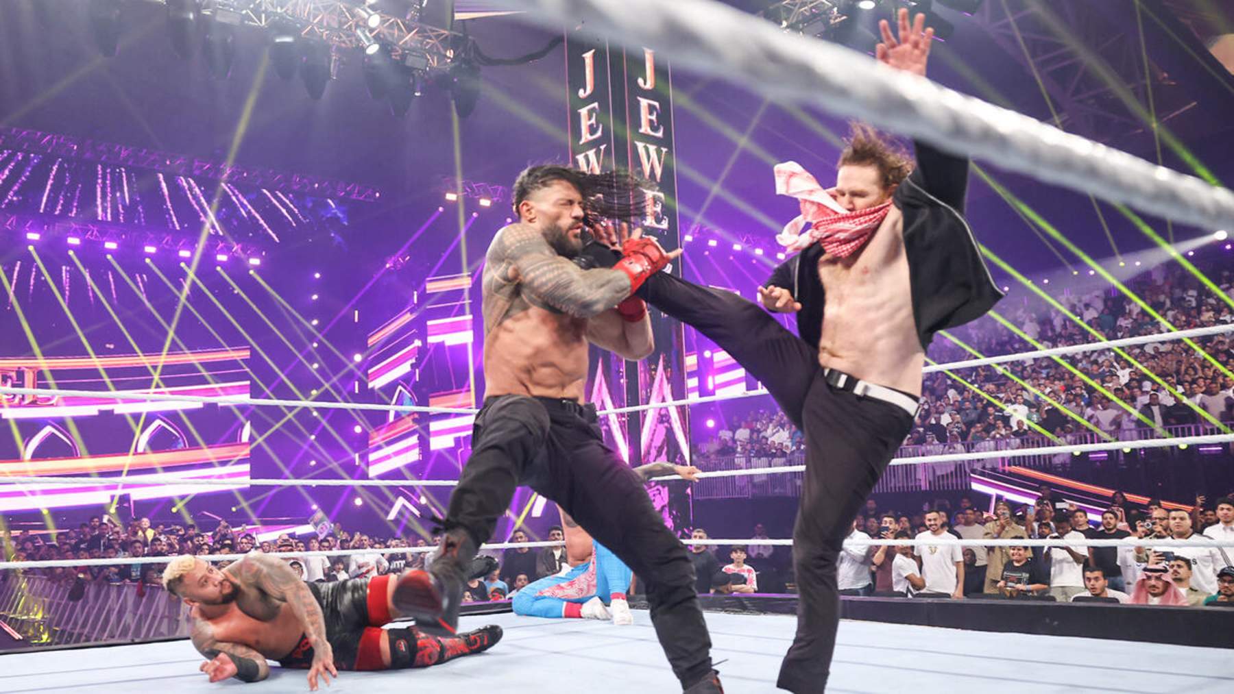 Sami Zayn kicking Roman Reigns at Crown Jewel.
