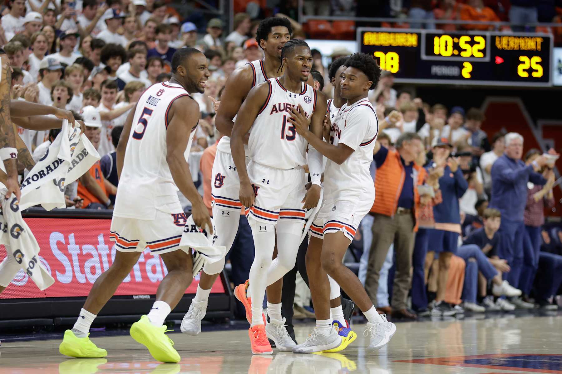 AUBURN, ALABAMA - NOVEMBER 6: Teammates celebrate with Miles Kelly #13 of the Auburn Tigers during the second half against the Vermont Catamounts at Neville Arena on November 6, 2024 in Auburn, Alabama. (Photo by Stew Milne/Getty Images)