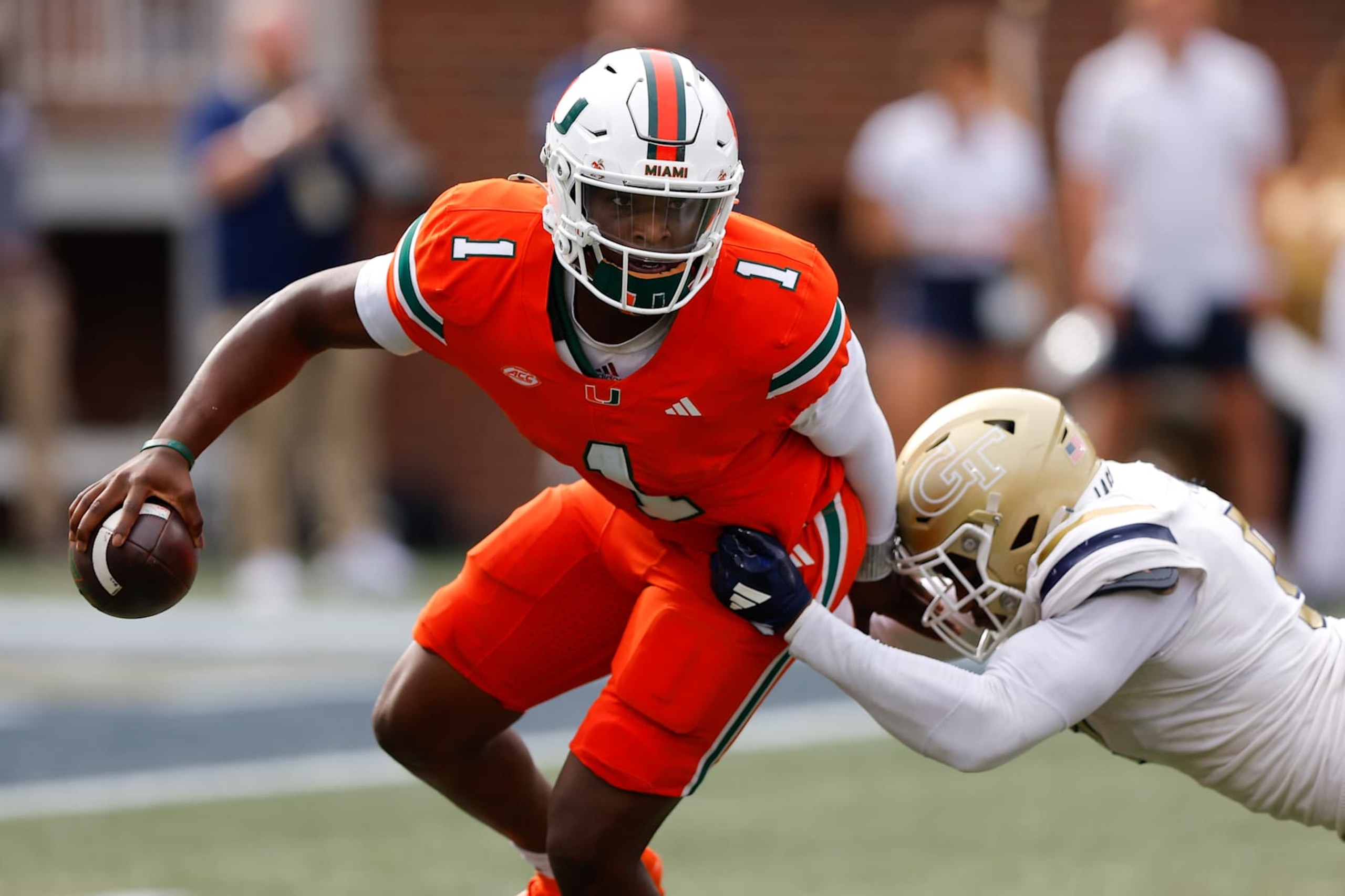 ATLANTA, GEORGIA - NOVEMBER 9: Cam Ward #1 of the Miami Hurricanes is pressured by Romello Height #9 of the Georgia Tech Yellow Jackets during the third quarter at Bobby Dodd Stadium on November 9, 2024 in Atlanta, Georgia. (Photo by Todd Kirkland/Getty Images) ATLANTA, GEORGIA - NOVEMBER 9: Cam Ward #1 of the Miami Hurricanes is pressured by Romello Height #9 of the Georgia Tech Yellow Jackets during the third quarter at Bobby Dodd Stadium on November 9, 2024 in Atlanta, Georgia. (Photo by Todd Kirkland/Getty Images)