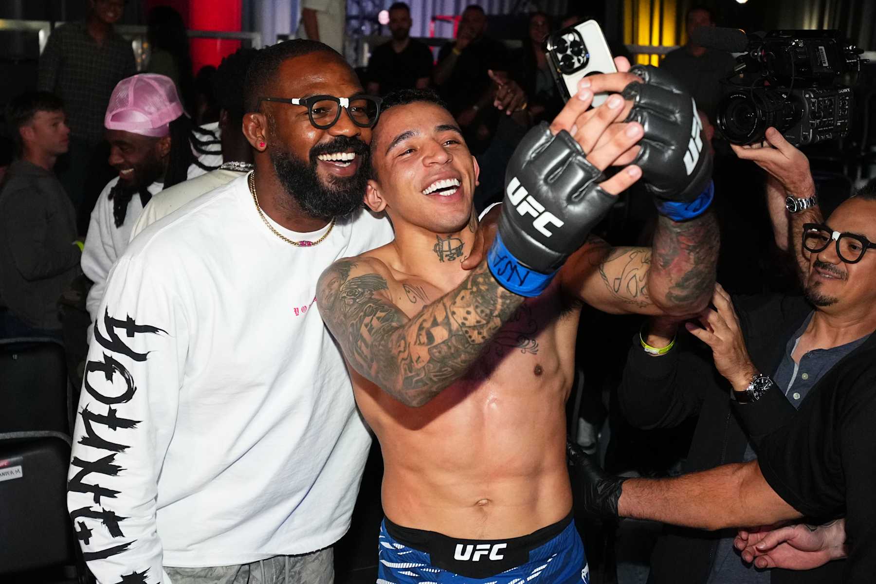 LAS VEGAS, NEVADA - NOVEMBER 09: Carlos Prates of Brazil poses with Jon Jones after a knockout victory against Neil Magny in a welterweight fight during the UFC Fight Night event at UFC APEX on November 09, 2024 in Las Vegas, Nevada. (Photo by Chris Unger/Zuffa LLC)