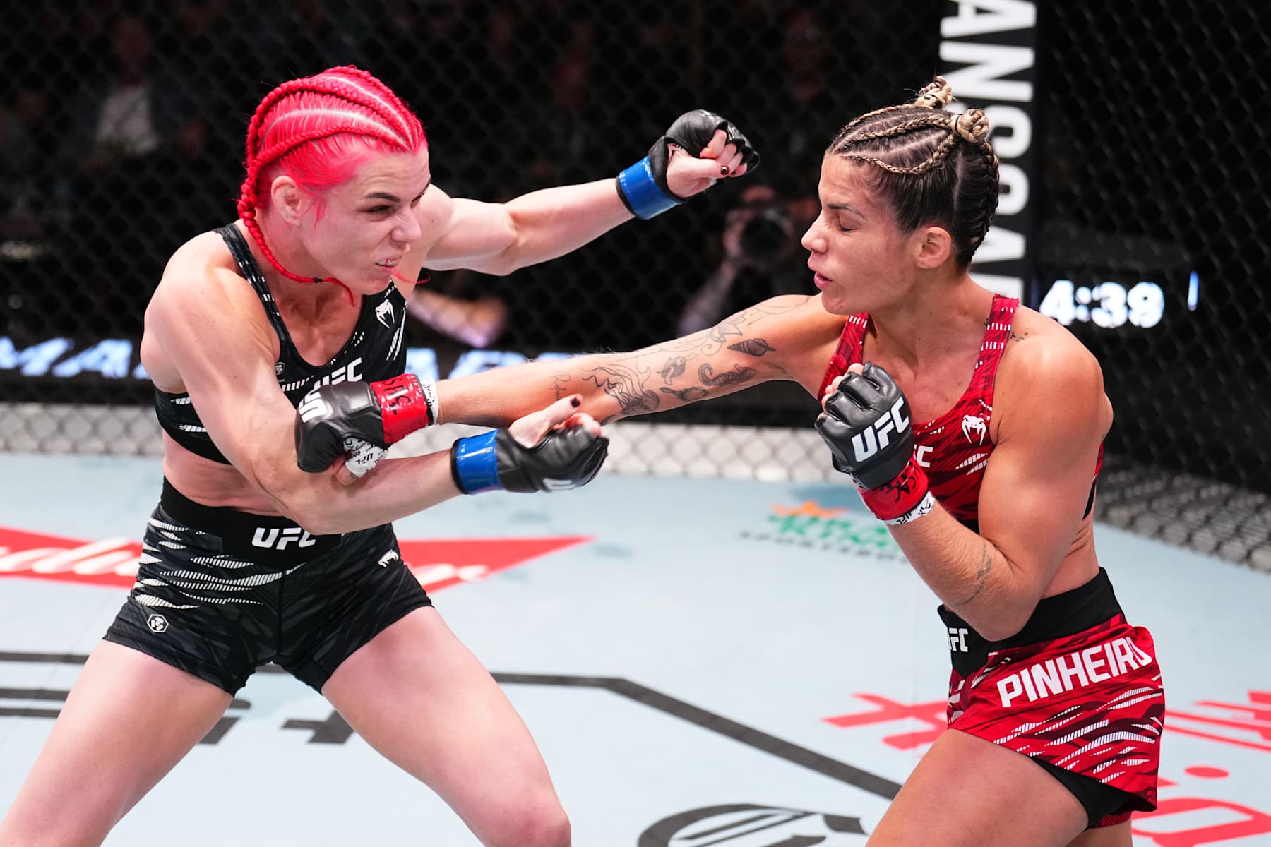 LAS VEGAS, NEVADA - NOVEMBER 09: (R-L) Luana Pinheiro of Brazil punches Gillian Robertson of Canada in a strawweight fight during the UFC Fight Night event at UFC APEX on November 09, 2024 in Las Vegas, Nevada. (Photo by Chris Unger/Zuffa LLC)