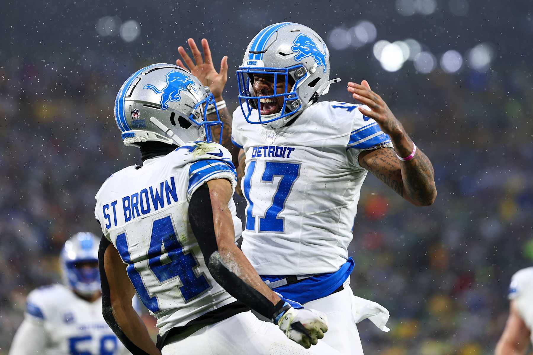 GREEN BAY, WISCONSIN - NOVEMBER 03: Amon-Ra St. Brown #14 of the Detroit Lions celebrates with Tim Patrick #17 after scoring a touchdown during the first half of an NFL football game against the Green Bay Packers at Lambeau Field on November 3, 2024 in Green Bay, Wisconsin. (Photo by Kevin Sabitus/Getty Images)