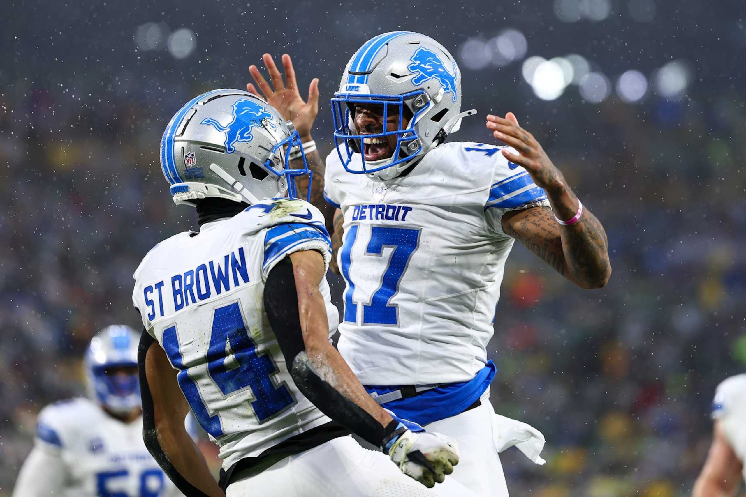 GREEN BAY, WISCONSIN - NOVEMBER 03: Amon-Ra St. Brown #14 of the Detroit Lions celebrates with Tim Patrick #17 after scoring a touchdown during the first half of an NFL football game against the Green Bay Packers at Lambeau Field on November 3, 2024 in Green Bay, Wisconsin. (Photo by Kevin Sabitus/Getty Images)