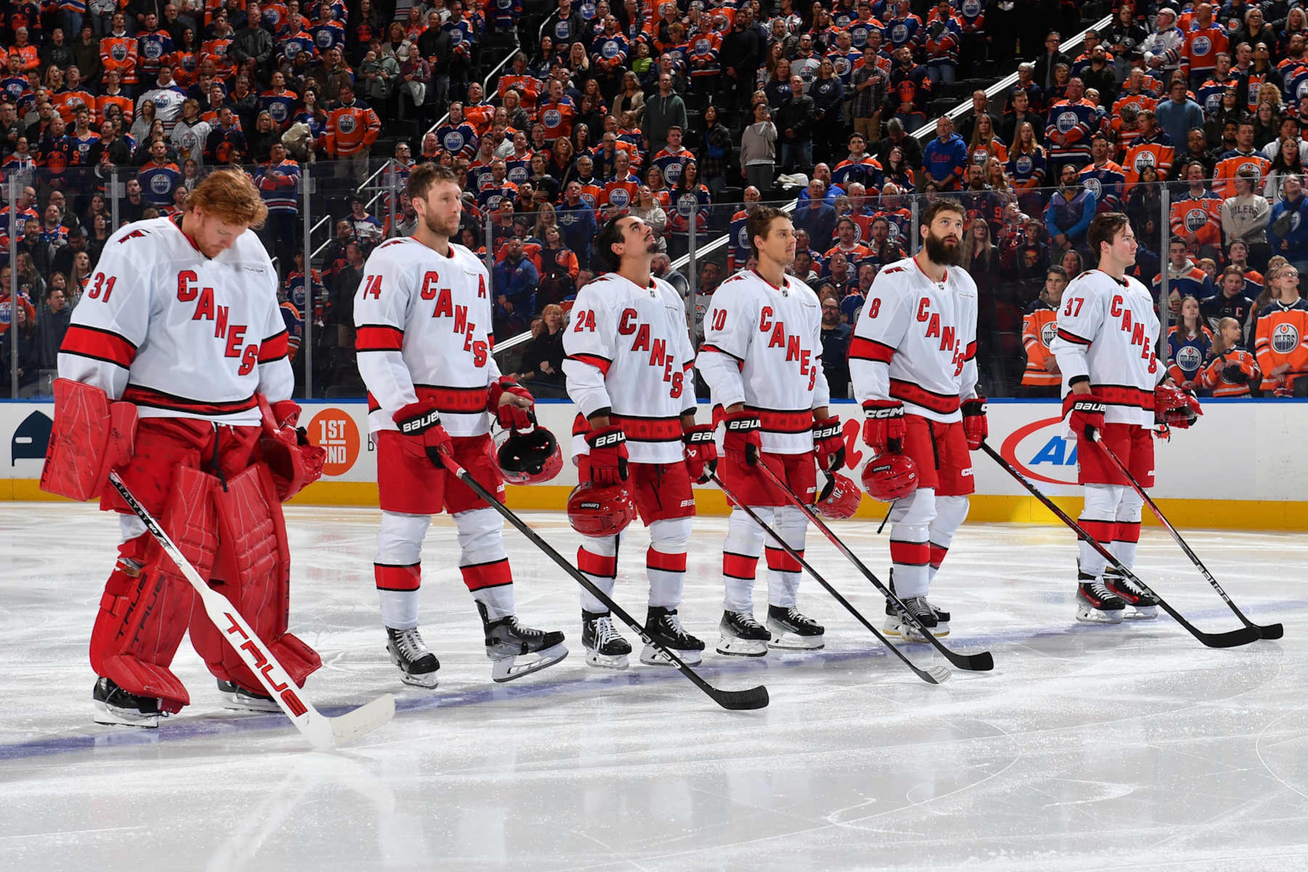 EDMONTON, CANADA - OCTOBER 22: Frederik Andersen #31, Jaccob Slavin #74, Seth Jarvis #24, Sebastian Aho #20, Brent Burns #8 and Andrei Svechnikov #37 of the Carolina Hurricanes stand for the playing of the national anthem before the game against the Edmonton Oilers at Rogers Place on October 22, 2024, in Edmonton, Alberta, Canada. (Photo by Andy Devlin/NHLI via Getty Images)