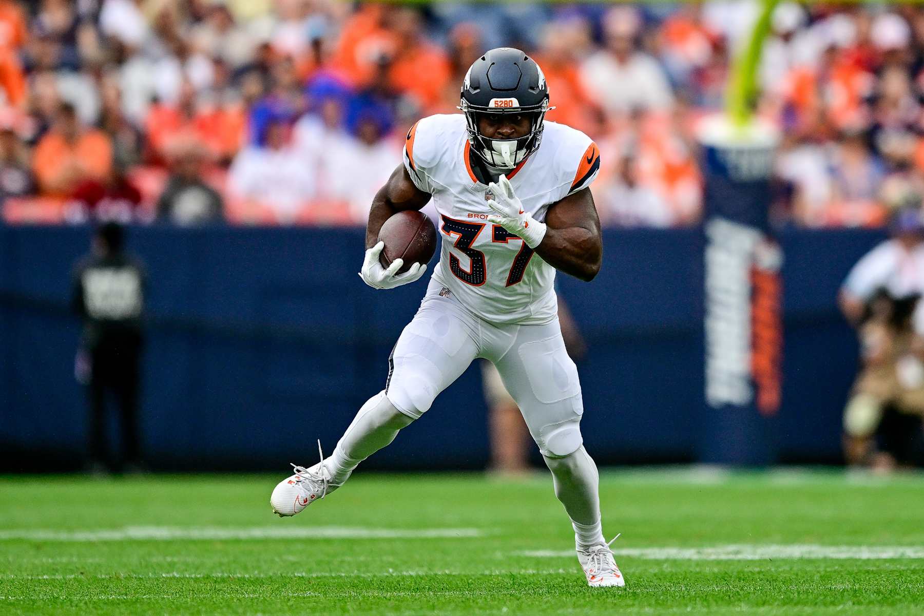 DENVER, COLORADO - AUGUST 25: Audric Estime #37 of the Denver Broncos carries the ball in the first quarter against the Arizona Cardinals during the preseason game at Empower Field at Mile High on August 25, 2024 in Denver, Colorado. (Photo by Dustin Bradford/Getty Images)