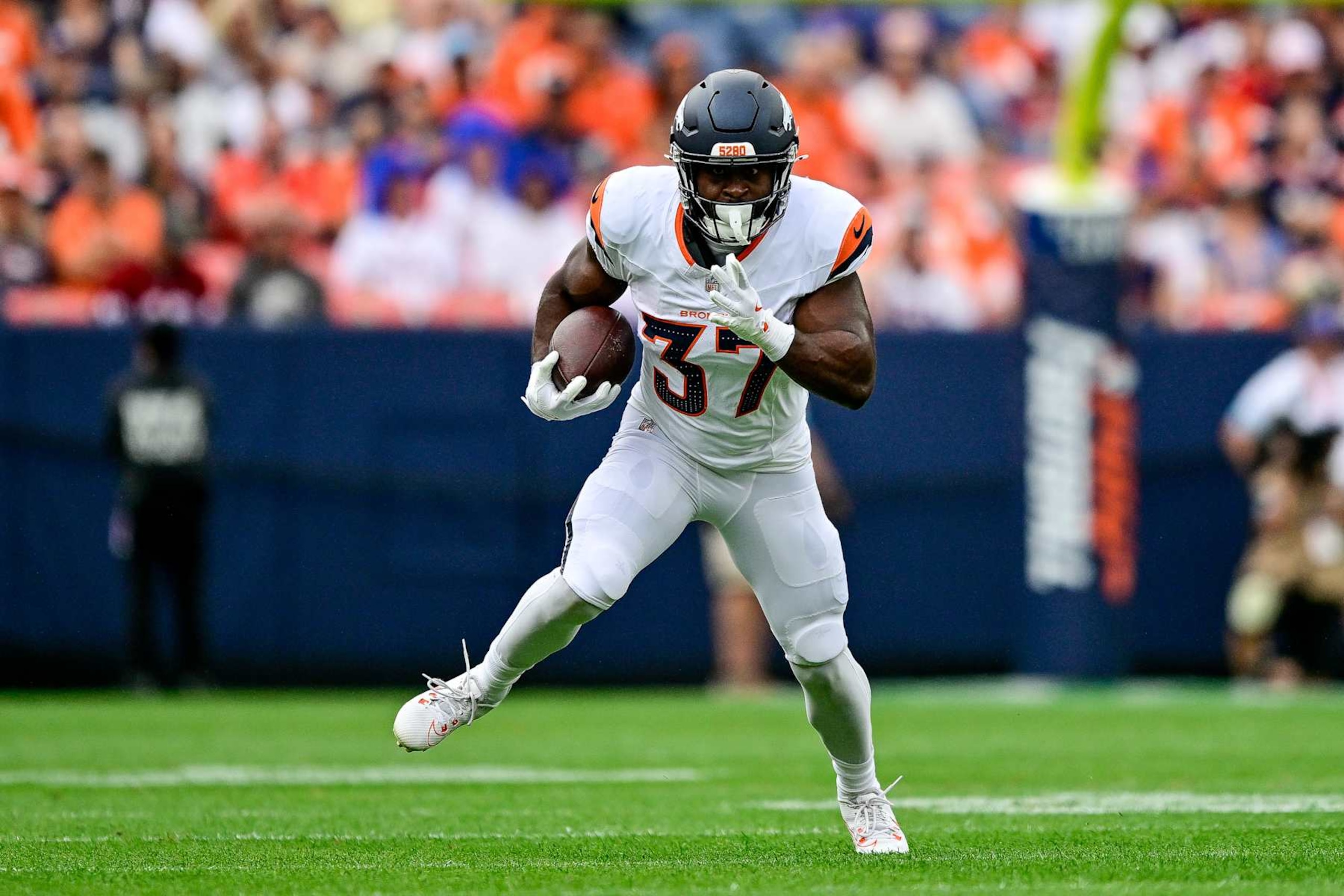 DENVER, COLORADO - AUGUST 25:  Audric Estime #37 of the Denver Broncos carries the ball in the first quarter against the Arizona Cardinals during the preseason game at Empower Field at Mile High on August 25, 2024 in Denver, Colorado. (Photo by Dustin Bradford/Getty Images)