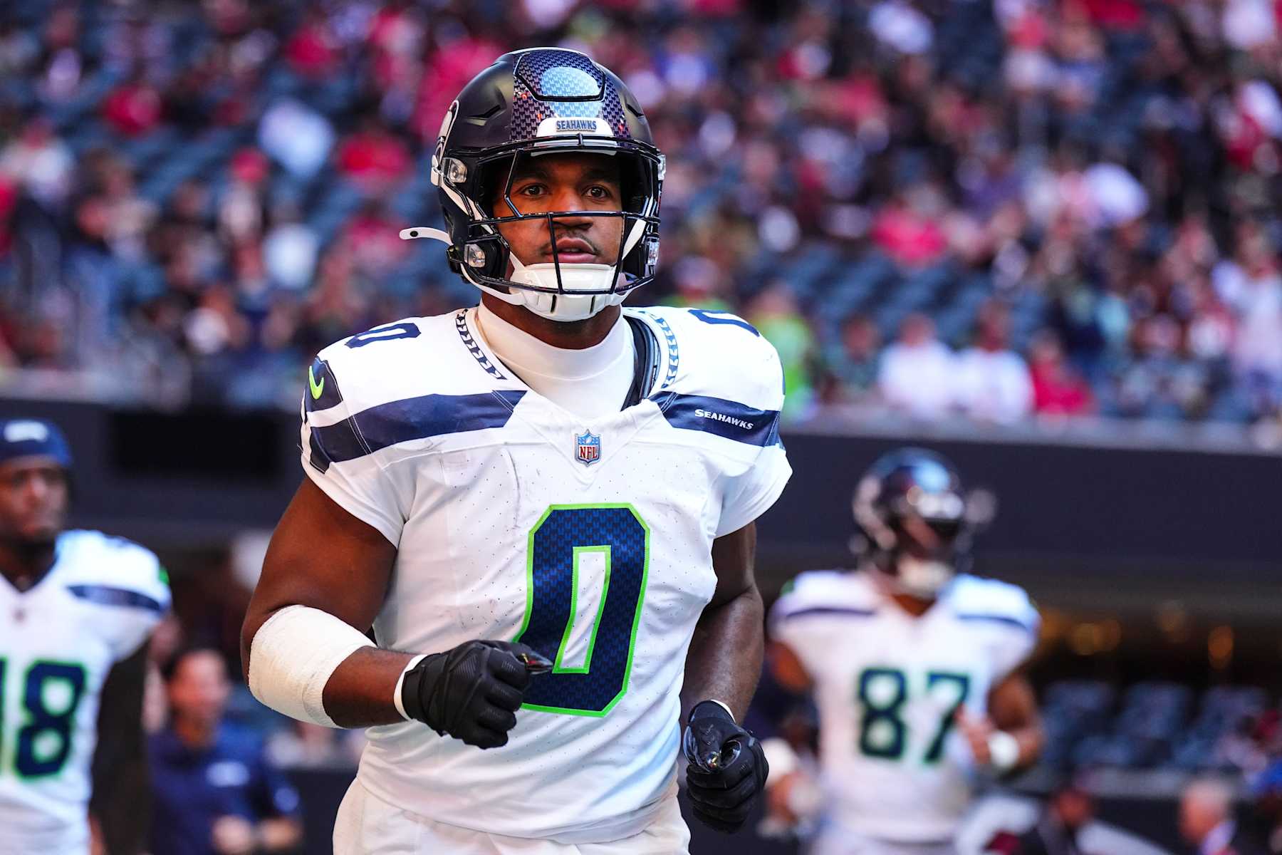 ATLANTA, GA - OCTOBER 20: Tyrel Dodson #0 of the Seattle Seahawks runs out of the tunnel prior to an NFL football game against the Atlanta Falcons at Mercedes-Benz Stadium on October 20, 2024 in Atlanta, Georgia. (Photo by Cooper Neill/Getty Images)