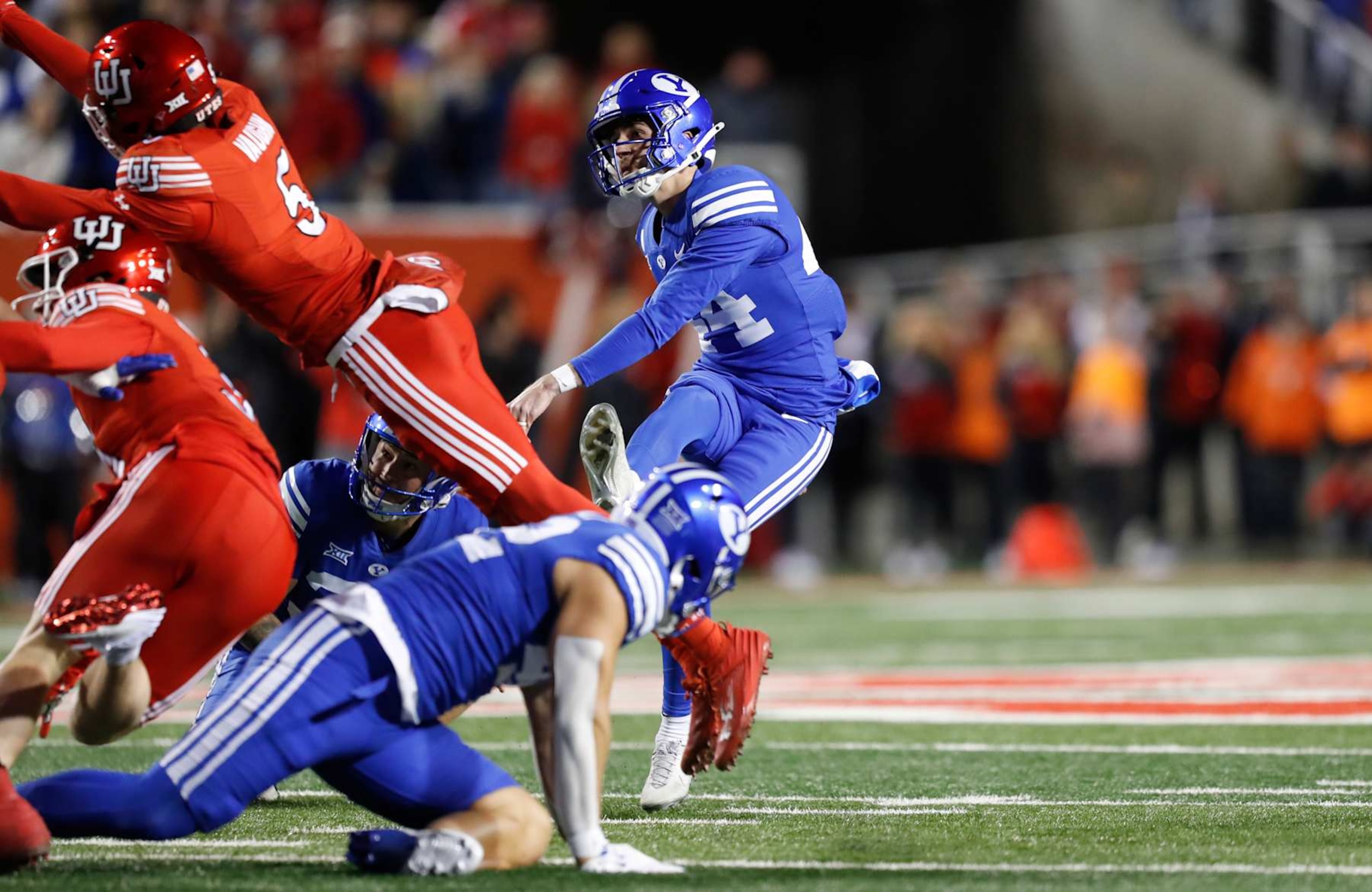 SALT LAKE CITY, UT - NOVEMBER 9:  Will Ferrin #44 of the Brigham Young Cougars kicks a game winning field goal during the second half of their game against the Utah Utes at Rice-Eccles Stadium on November 9, 2024 in Salt Lake City, Utah.(Photo by Chris Gardner/Getty Images)