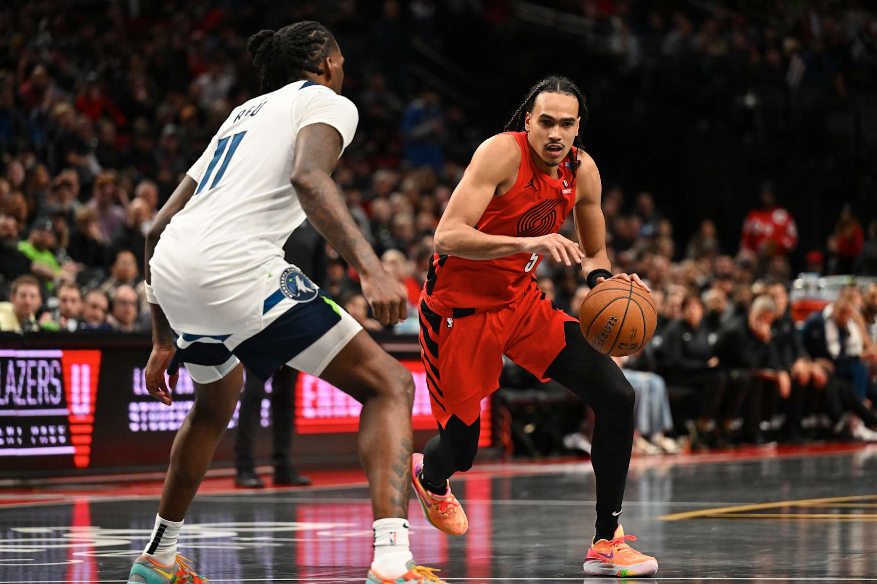 PORTLAND, OREGON - NOVEMBER 12: Dalano Banton #5 of the Portland Trail Blazers dribbles against Naz Reid #11 of the Minnesota Timberwolves during the fourth quarter of the Emirates NBA Cup at Moda Center on November 12, 2024 in Portland, Oregon. The Portland Trail Blazers won 122-108. NOTE TO USER: User expressly acknowledges and agrees that, by downloading and or using this photograph, User is consenting to the terms and conditions of the Getty Images License Agreement. (Photo by Alika Jenner/Getty Images) PORTLAND, OREGON - NOVEMBER 12: Dalano Banton #5 of the Portland Trail Blazers dribbles against Naz Reid #11 of the Minnesota Timberwolves during the fourth quarter of the Emirates NBA Cup at Moda Center on November 12, 2024 in Portland, Oregon. The Portland Trail Blazers won 122-108. NOTE TO USER: User expressly acknowledges and agrees that, by downloading and or using this photograph, User is consenting to the terms and conditions of the Getty Images License Agreement. (Photo by Alika Jenner/Getty Images)