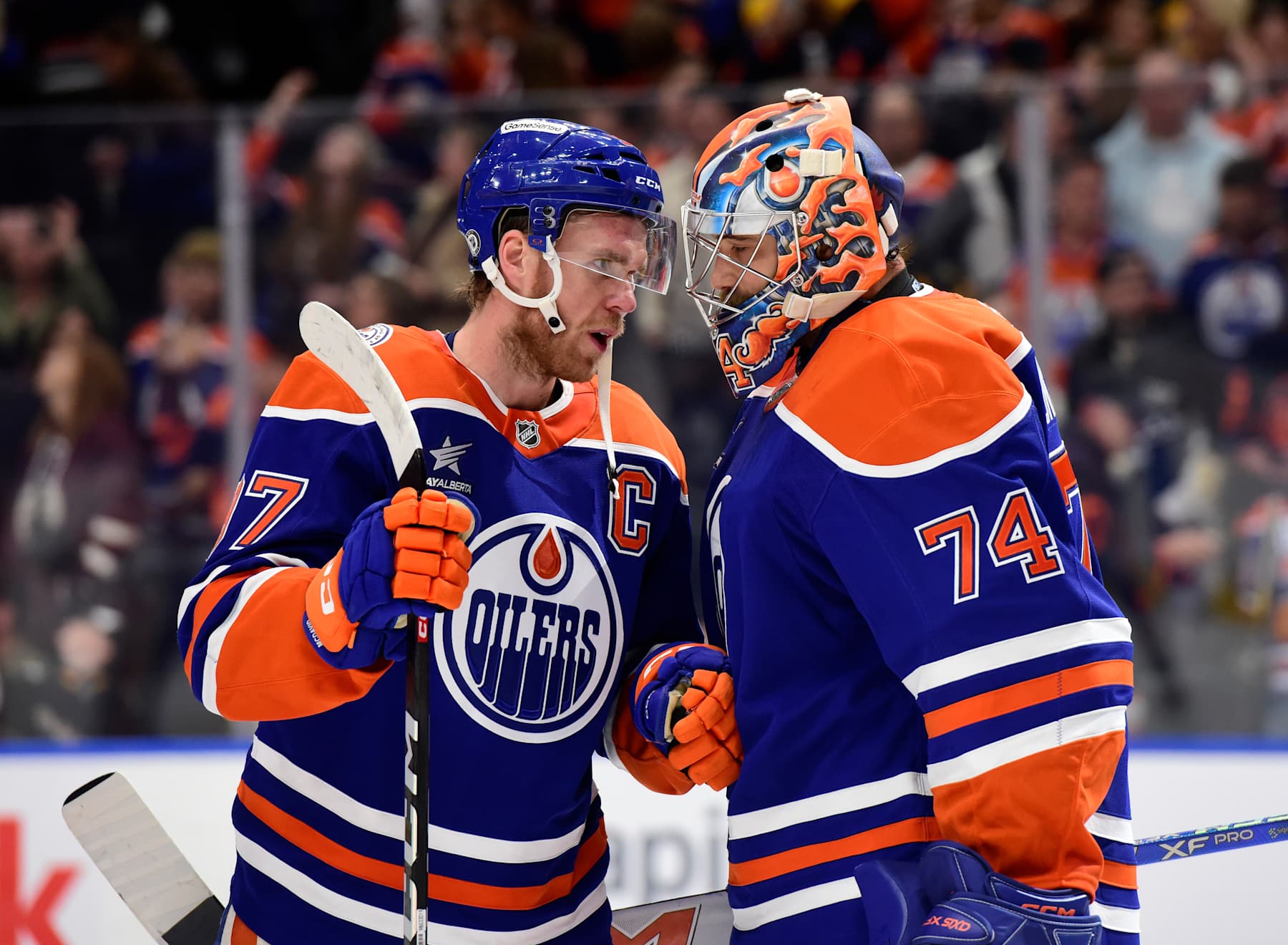 EDMONTON, CANADA OCTOBER 25: Connor McDavid #97 and Stuart Skinner #74 of the Edmonton Oilers celebrate a victory over the Pittsburgh Penguins after the game at Rogers Place on October 15, 2024, in Edmonton, Alberta, Canada. (Photo by Leila Devlin/Getty Images)