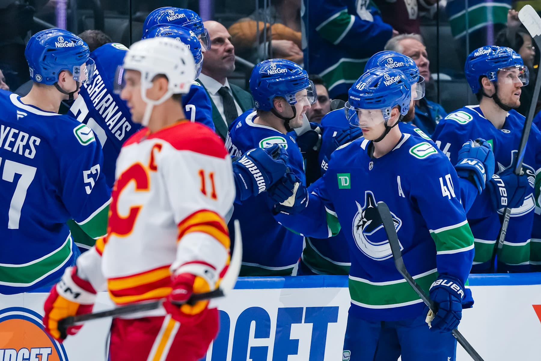 VANCOUVER, CANADA - NOVEMBER 12: Elias Pettersson #40 of the Vancouver Canucks celebrates scoring as Mikael Backlund #11 of the Calgary Flames skates by during the second period at Rogers Arena on November 12, 2024 in Vancouver, British Columbia, Canada. (Photo by Derek Cain/Getty Images)