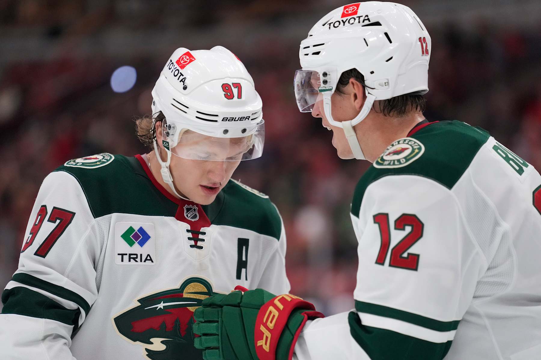 CHICAGO, ILLINOIS - NOVEMBER 10: Kirill Kaprizov #97 and Matt Boldy #12 of the Minnesota Wild talk during the third period against the Chicago Blackhawks at the United Center on November 10, 2024 in Chicago, Illinois. (Photo by Patrick McDermott/Getty Images)