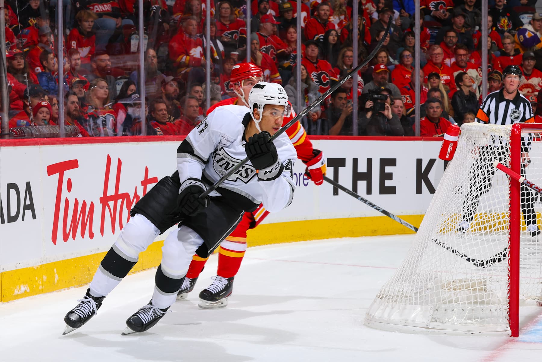 CALGARY, AB - NOVEMBER 11: Tyson Barrie #8 of the Calgary Flames skates against Andre Lee #47 of the Los Angeles Kings at Scotiabank Saddledome on November 11, 2024 in Calgary, Alberta, Canada. (Photo by Gerry Thomas/NHLI via Getty Images)