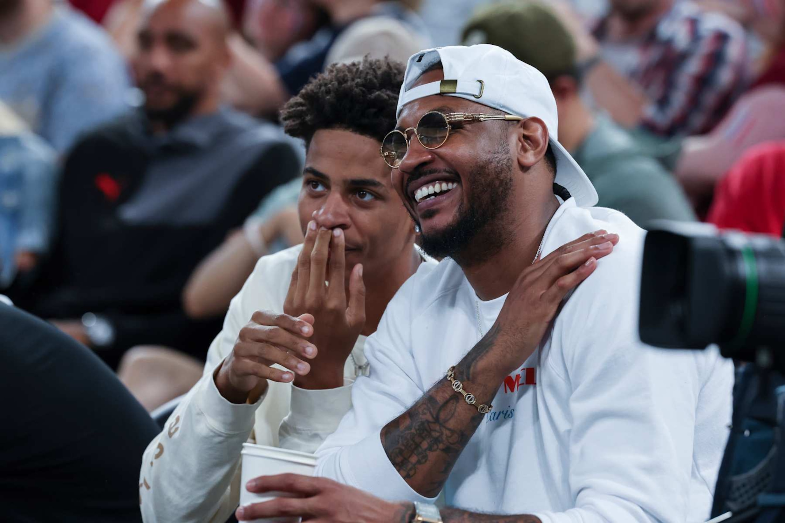 PARIS, FRANCE - AUGUST 8: Carmelo Anthony and his son Kiyan Anthony attend the Men's Semifinal match between Team France and Team Germany on day thirteen of the Olympic Games Paris 2024 at Bercy Arena on August 8, 2024 in Paris, France. (Photo by Catherine Steenkeste/Getty Images)