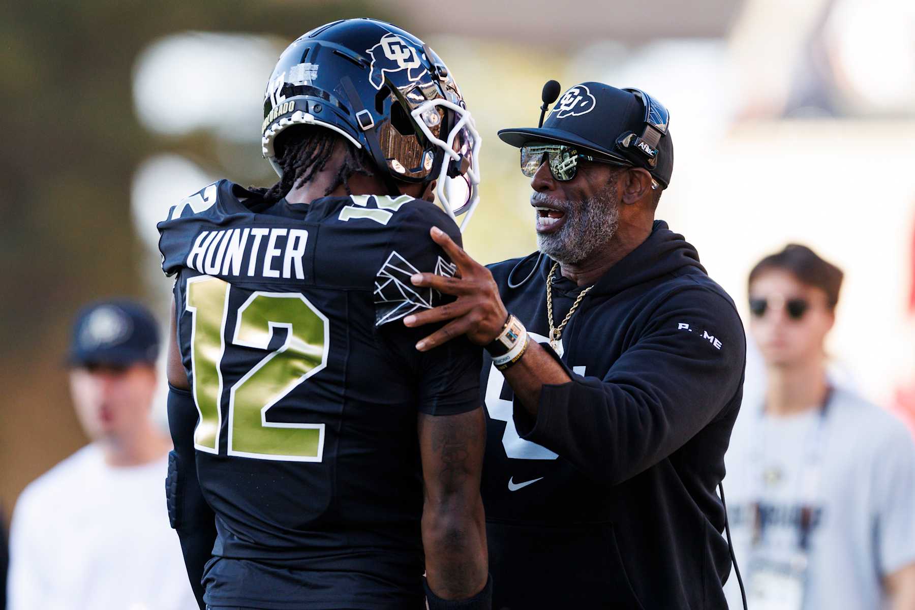 BOULDER, COLORADO - AUGUST 29: Deion Sanders of the Colorado Buffaloes and Travis Hunter #12 of the Colorado Buffaloes  on the sideline during a game against North Dakota State Bison at Folsom Field on August 29, 2024 in Boulder, Colorado. (Photo by Ric Tapia/Getty Images)