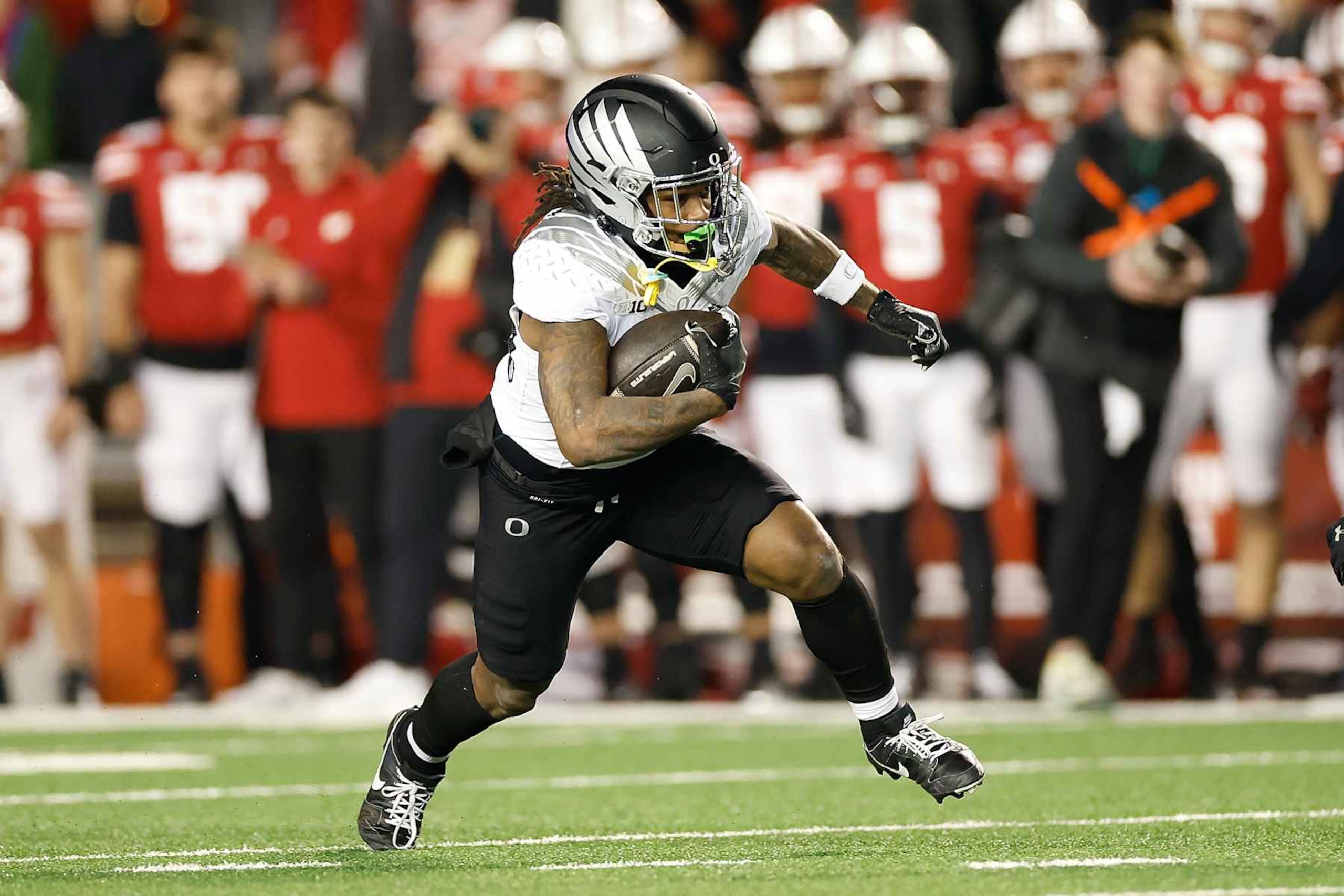 MADISON, WISCONSIN - NOVEMBER 16: Jordan James #20 of the Oregon Ducks rushes the ball in the first quarter against the Wisconsin Badgers at Camp Randall Stadium on November 16, 2024 in Madison, Wisconsin. (Photo by John Fisher/Getty Images) MADISON, WISCONSIN - NOVEMBER 16: Jordan James #20 of the Oregon Ducks rushes the ball in the first quarter against the Wisconsin Badgers at Camp Randall Stadium on November 16, 2024 in Madison, Wisconsin. (Photo by John Fisher/Getty Images)