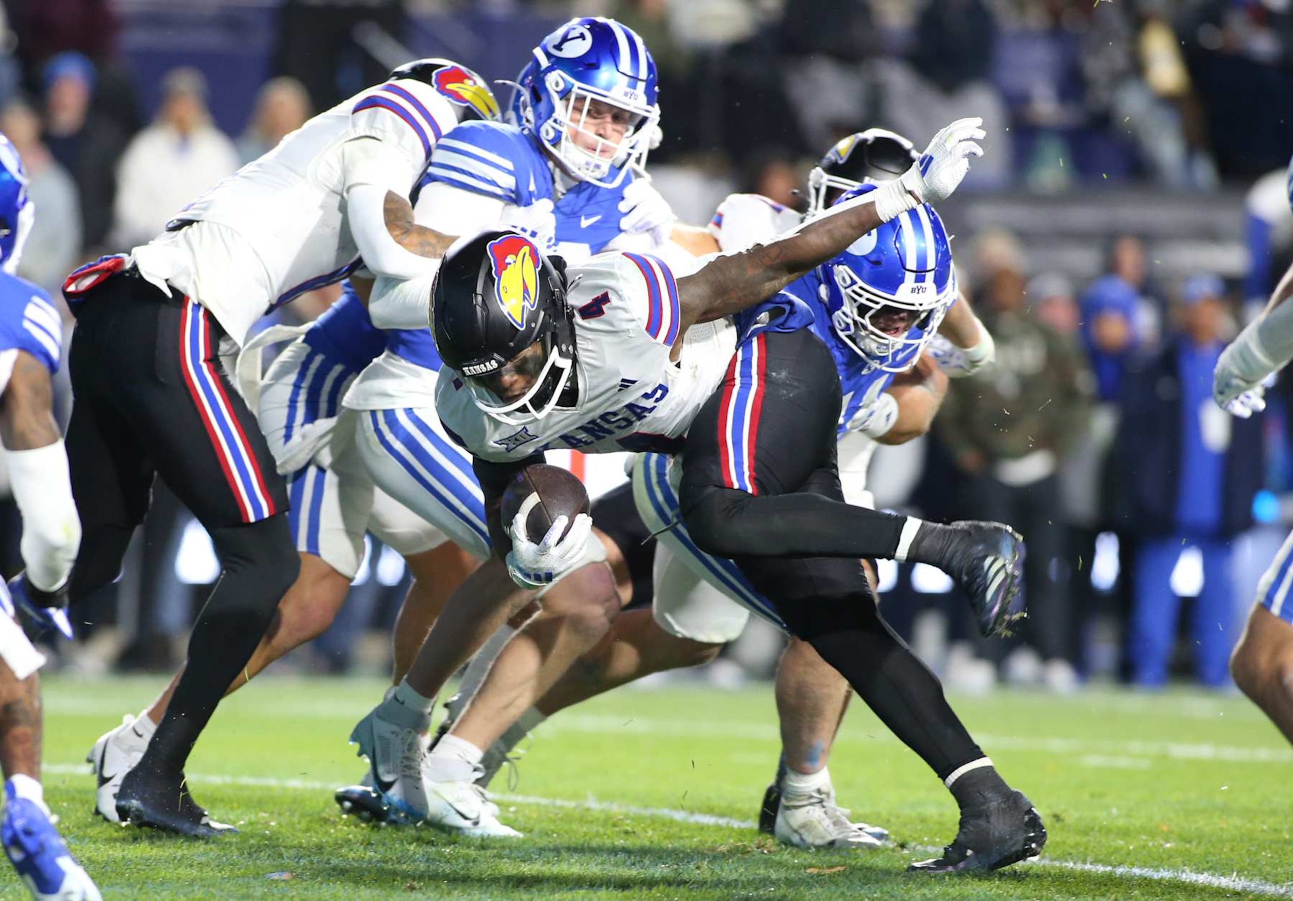 PROVO, UT - NOVEMBER 16: Devin Neal #4 of the Kansas Jayhawks rushes the ball for a touchdown against the Brigham Young Cougars during the first half of their game at LaVell Edwards Stadium on November 16, 2024 in Provo, Utah.(Photo by Chris Gardner/Getty Images) PROVO, UT - NOVEMBER 16: Devin Neal #4 of the Kansas Jayhawks rushes the ball for a touchdown against the Brigham Young Cougars during the first half of their game at LaVell Edwards Stadium on November 16, 2024 in Provo, Utah.(Photo by Chris Gardner/Getty Images)