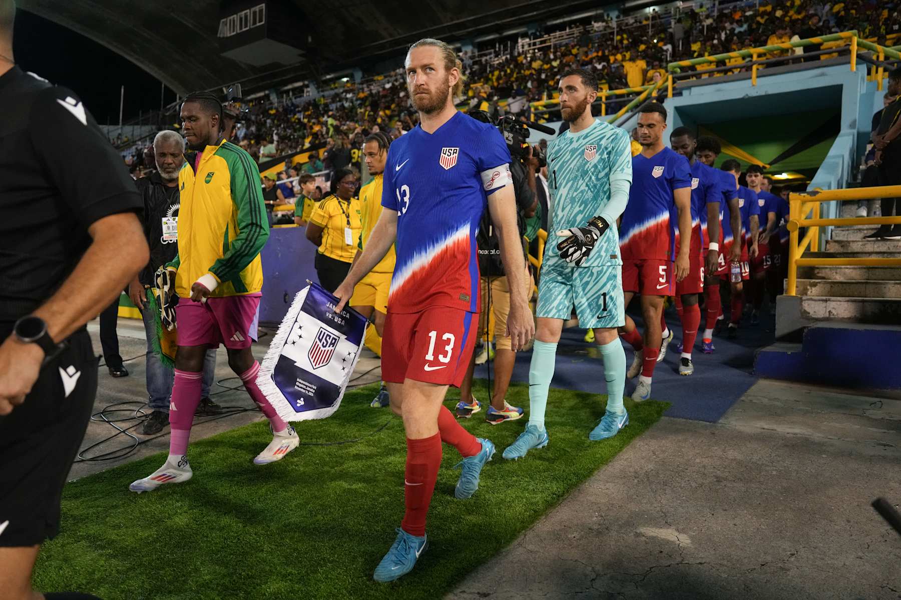 KINGSTON, JAMAICA - NOVEMBER 14: Captain Tim Ream #13 of the United States leads the team onto the field prior to playing against Jamaica at National Stadium on November 14, 2024 in Kingston, Jamaica. (Photo by Brad Smith/ISI Photos/USSF/Getty Images for USSF)