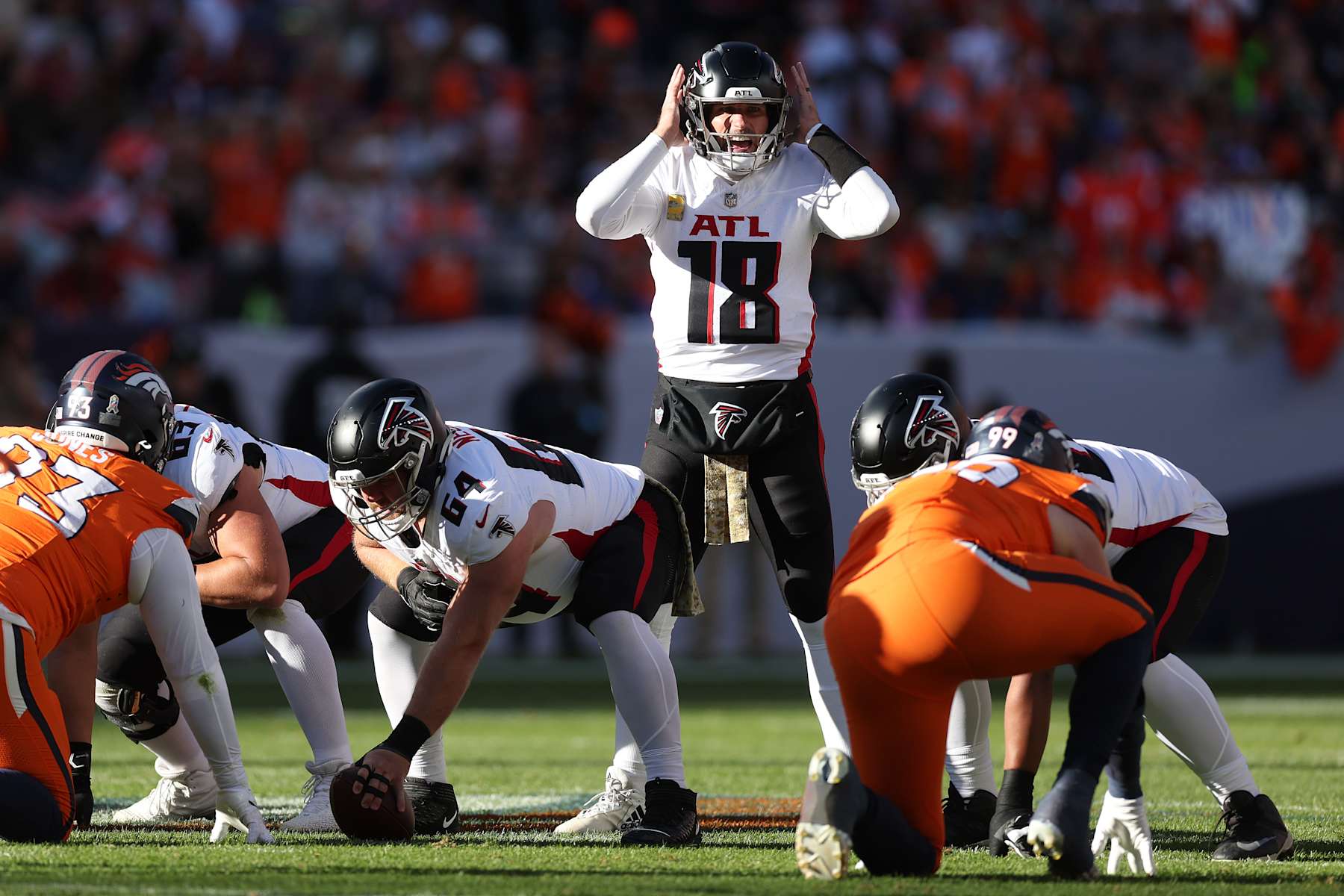 DENVER, COLORADO - NOVEMBER 17: Quarterback Kirk Cousins #18 of the Atlanta Falcons calls out orders at the line of scrimmage during the first quarter against the Denver Broncos at Empower Field At Mile High on November 17, 2024 in Denver, Colorado. (Photo by Matthew Stockman/Getty Images)