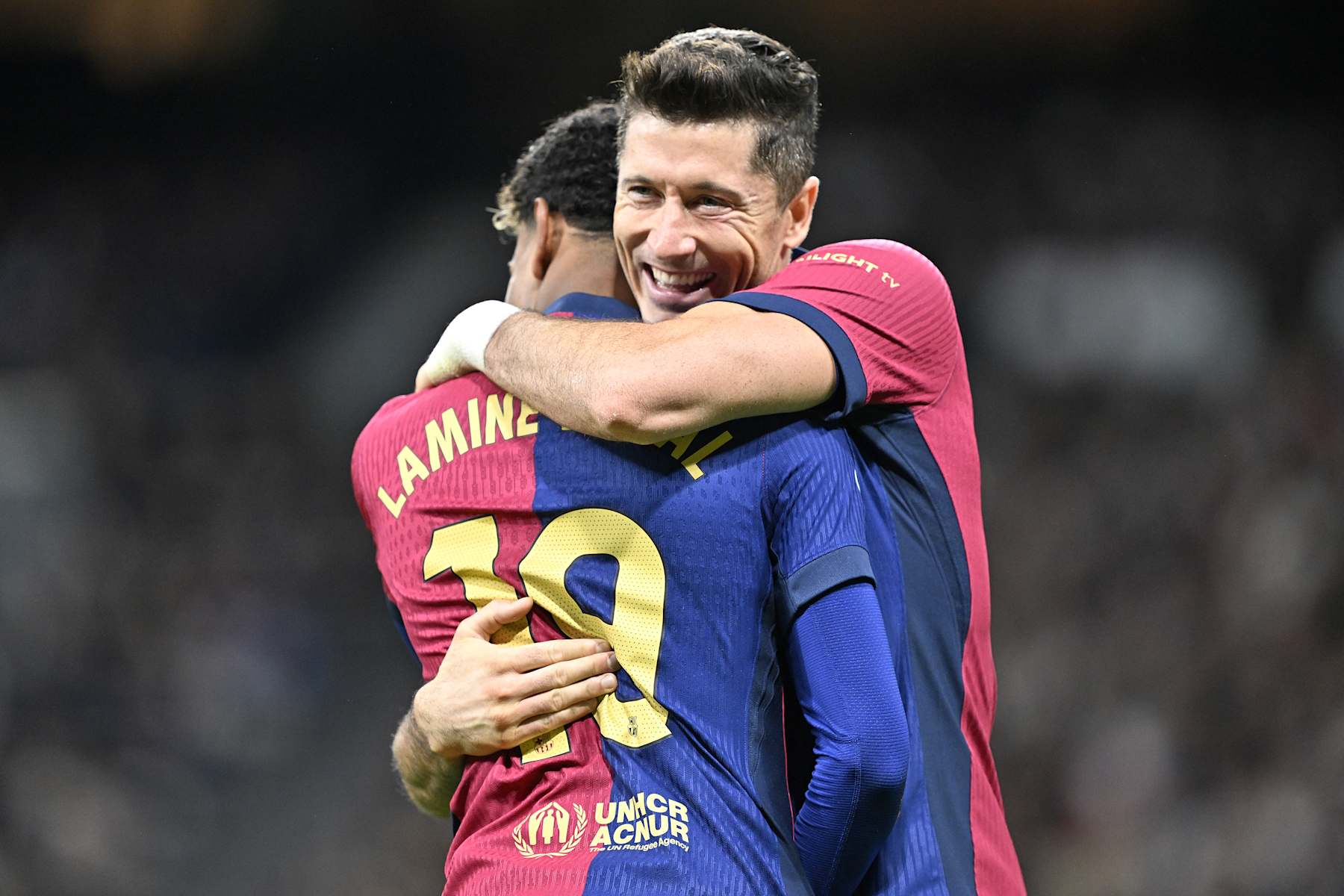 MADRID, SPAIN - OCTOBER 26: Lamine Yamal of Barcelona celebrates with Robert Lewandowski after scoring a goal during LaLiga football match between Real Madrid and Barcelona at Santiago Bernabeu in Madrid, Spain on October 26, 2024. (Photo by Burak Akbulut/Anadolu via Getty Images)