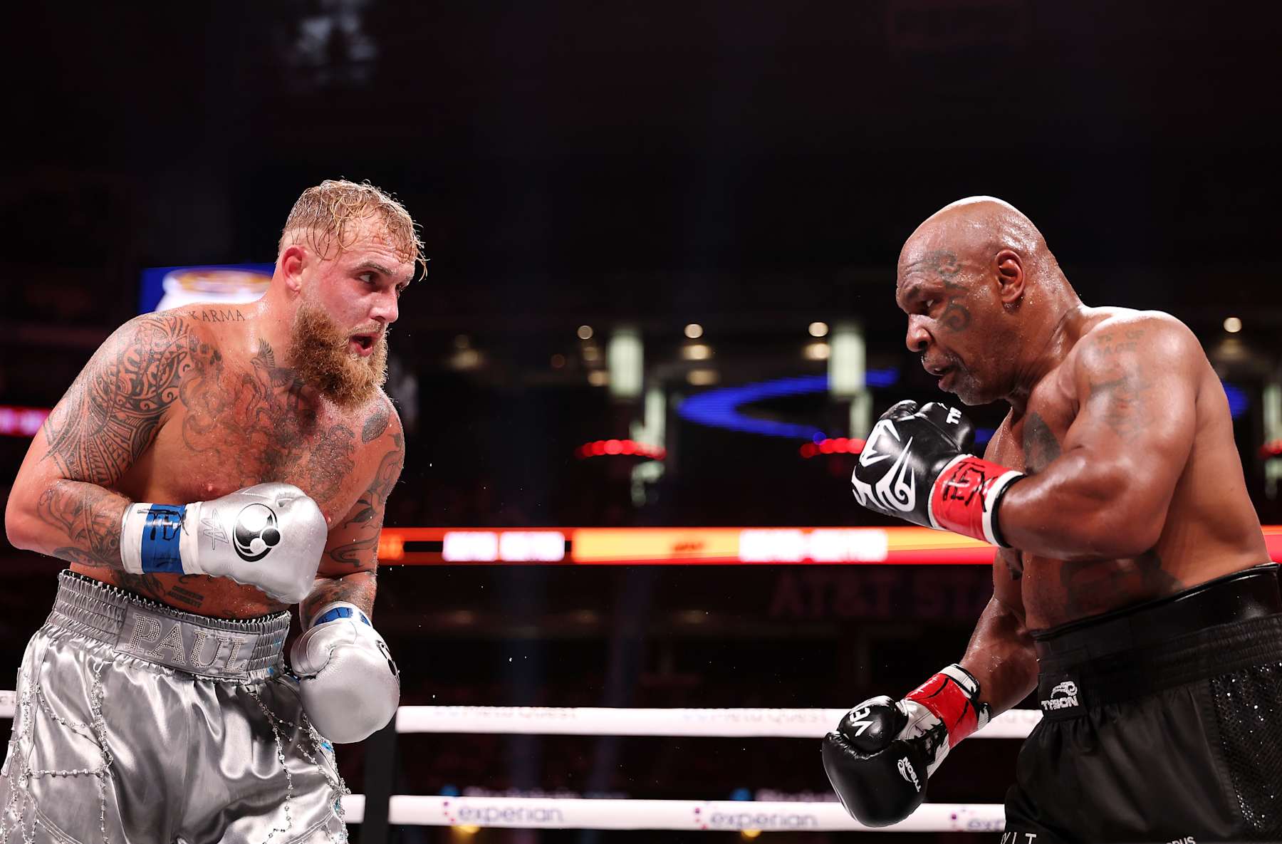 ARLINGTON, TEXAS - NOVEMBER 15: (L-R) Jake Paul and Mike Tyson fight during LIVE On Netflix: Jake Paul vs. Mike Tyson at AT&T Stadium on November 15, 2024 in Arlington, Texas. (Photo by Al Bello/Getty Images for Netflix © 2024) ARLINGTON, TEXAS - NOVEMBER 15: (L-R) Jake Paul and Mike Tyson fight during LIVE On Netflix: Jake Paul vs. Mike Tyson at AT&T Stadium on November 15, 2024 in Arlington, Texas. (Photo by Al Bello/Getty Images for Netflix © 2024)
