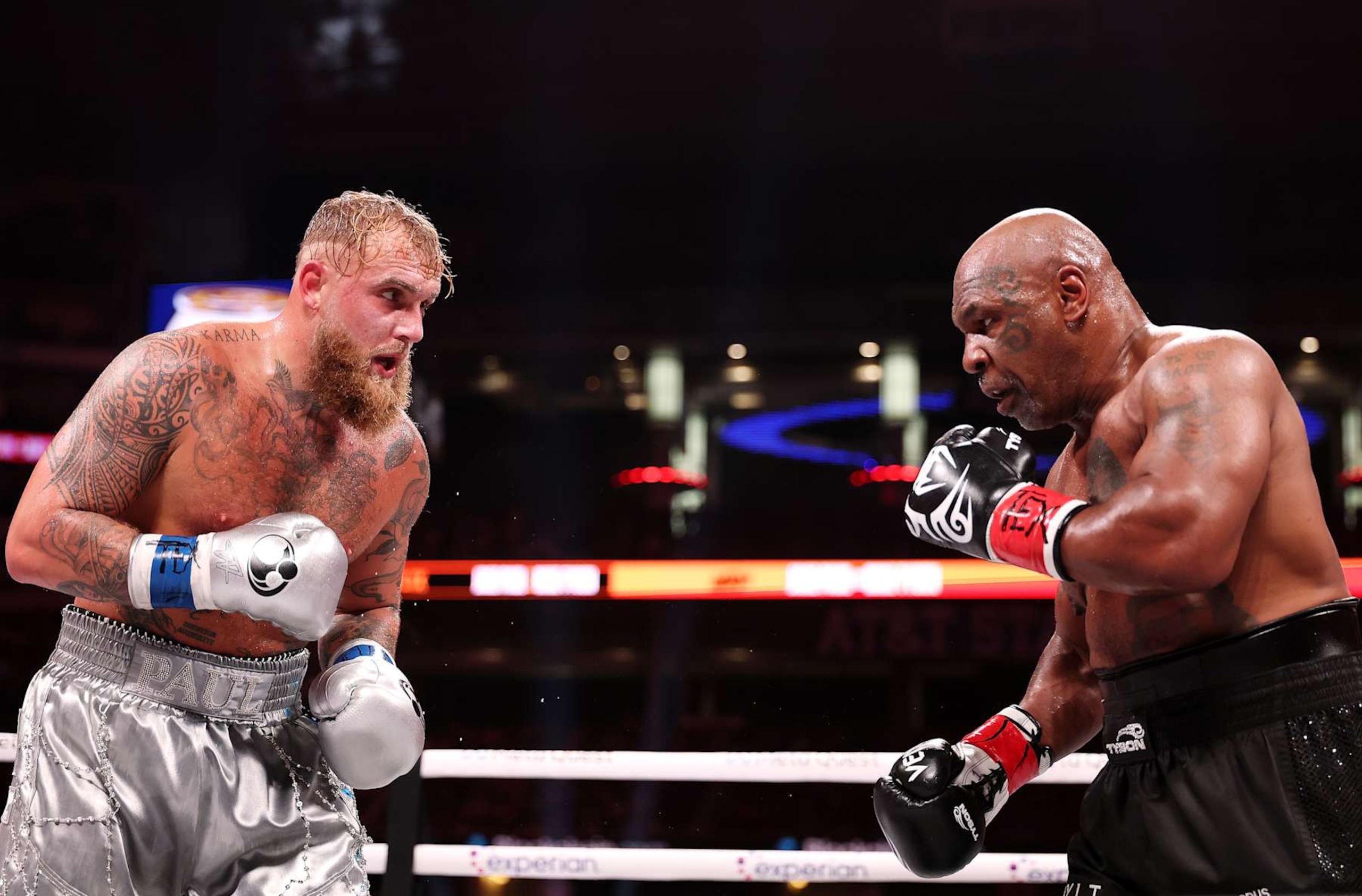 ARLINGTON, TEXAS - NOVEMBER 15: (L-R) Jake Paul and Mike Tyson fight during LIVE On Netflix: Jake Paul vs. Mike Tyson at AT&T Stadium on November 15, 2024 in Arlington, Texas. (Photo by Al Bello/Getty Images for Netflix © 2024) ARLINGTON, TEXAS - NOVEMBER 15: (L-R) Jake Paul and Mike Tyson fight during LIVE On Netflix: Jake Paul vs. Mike Tyson at AT&T Stadium on November 15, 2024 in Arlington, Texas. (Photo by Al Bello/Getty Images for Netflix © 2024)