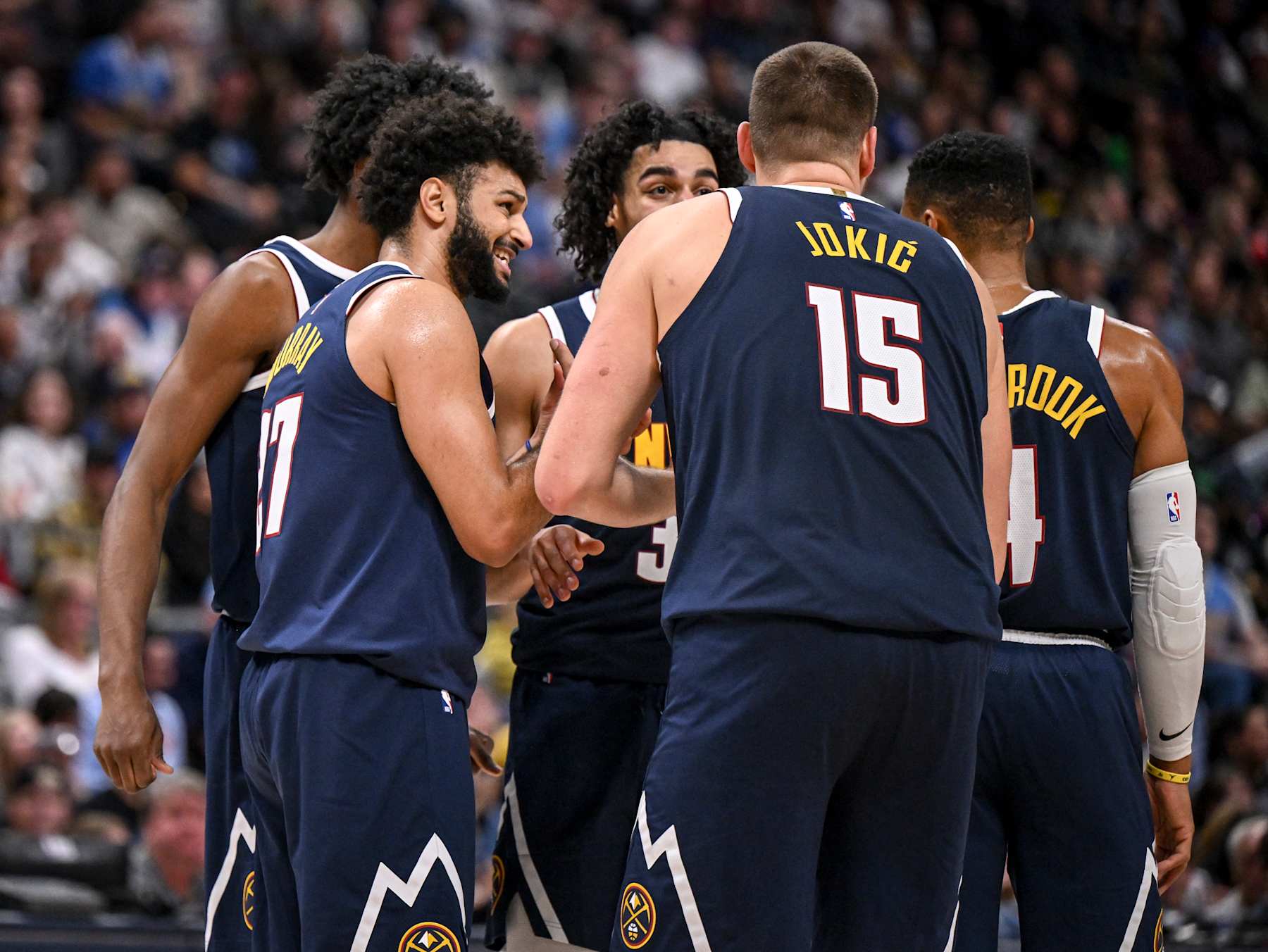 DENVER, CO - NOVEMBER 10: Jamal Murray (27) and Nikola Jokic (15) of the Denver Nuggets talk to teammates Peyton Watson (8), Julian Strawther (3) and Russell Westbrook (4) before a resumption of play against the Dallas Mavericks during the fourth quarter of the Nuggets' 122-120 win at Ball Arena in Denver, Colorado on Sunday, November 10, 2024. (Photo by AAron Ontiveroz/The Denver Post)